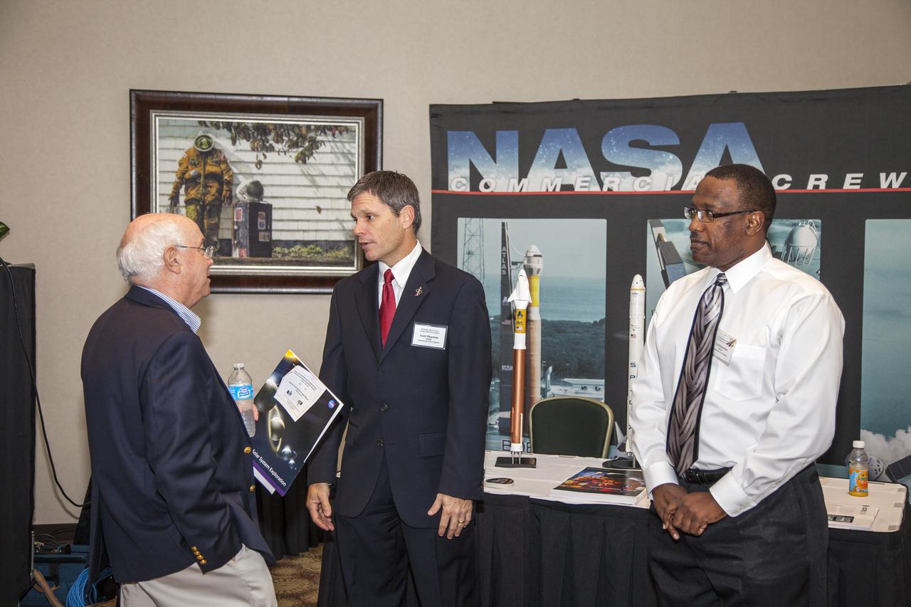 CAPE CANAVERAL, Fla. - Community leaders, business executives, educators, and state and local government leaders were updated on NASA Kennedy Space Center programs and accomplishments during Center Director Bob Cabana’s Center Director Update at the Debus Center at the Kennedy Space Center Visitor Complex in Florida. An attendee talks with Scott Thurston, Kennedy deputy of the spacecraft office at the Commercial Crew Program display. Attendees talked with Cabana and other senior Kennedy managers and visited displays featuring updates on Kennedy programs and projects, including International Space Station, Commercial Crew, Ground System Development and Operations, Launch Services, Center Planning and Development, Technology, KSC Swamp Works and NASA Education. The morning concluded with a tour of the new Space Shuttle Atlantis exhibit at the visitor complex. For more information, visit http://www.nasa.gov/kennedy. Photo credit: NASA/Daniel Casper