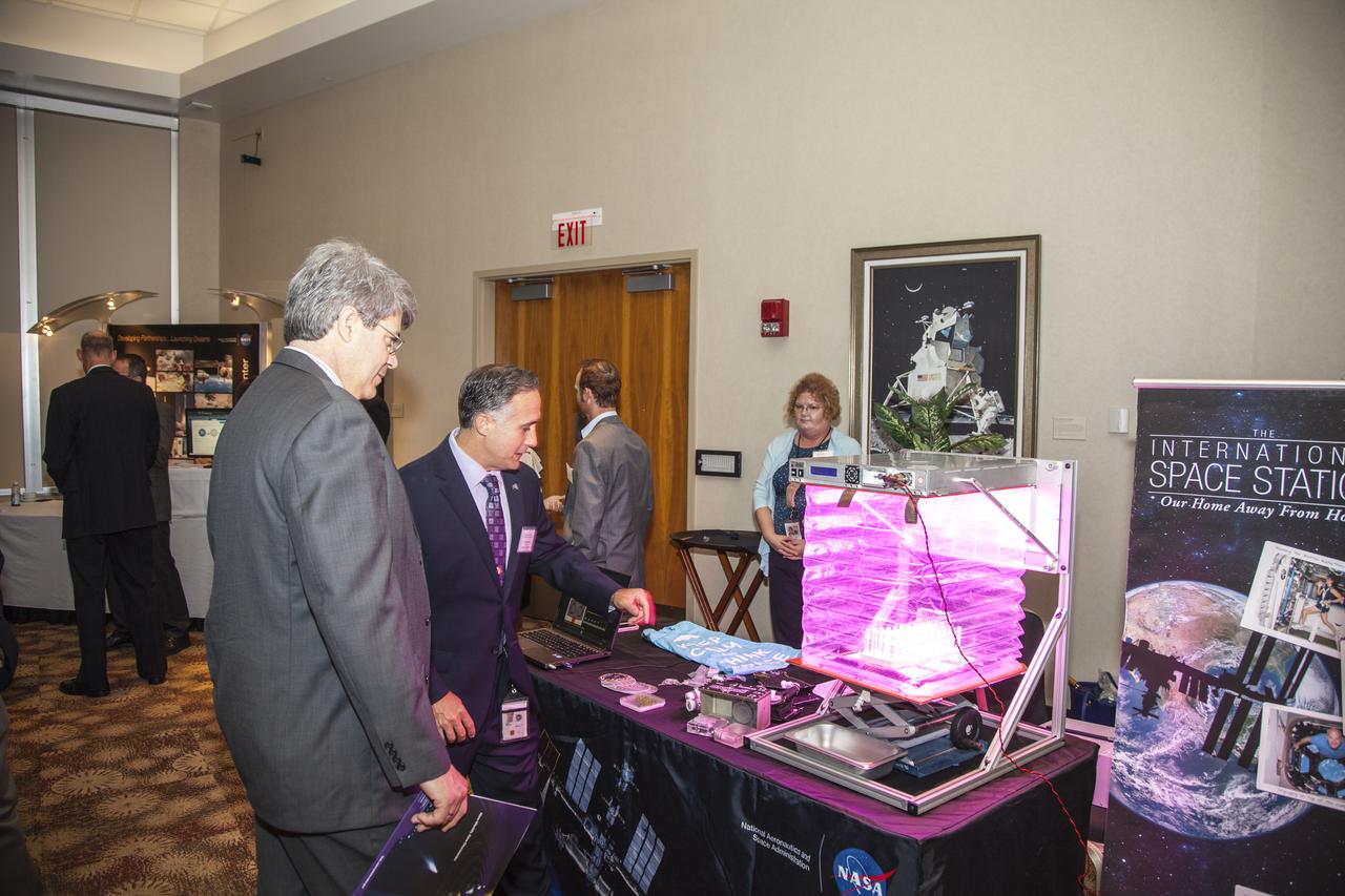 CAPE CANAVERAL, Fla. - Community leaders, business executives, educators, and state and local government leaders were updated on NASA Kennedy Space Center programs and accomplishments during Center Director Bob Cabana’s Center Director Update at the Debus Center at the Kennedy Space Center Visitor Complex in Florida. An attendee talks with Trent Smith, program manager, and Tammy Belk, a program specialist, at the ISS Ground Processing and Research Office display. Attendees talked with Cabana and other senior Kennedy managers and visited displays featuring updates on Kennedy programs and projects, including International Space Station, Commercial Crew, Ground System Development and Operations, Launch Services, Center Planning and Development, Technology, KSC Swamp Works and NASA Education. The morning concluded with a tour of the new Space Shuttle Atlantis exhibit at the visitor complex. For more information, visit http://www.nasa.gov/kennedy. Photo credit: NASA/Daniel Casper