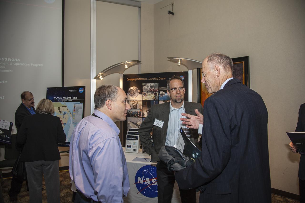 CAPE CANAVERAL, Fla. - Community leaders, business executives, educators, and state and local government leaders were updated on NASA Kennedy Space Center programs and accomplishments during Center Director Bob Cabana’s Center Director Update at the Debus Center at the Kennedy Space Center Visitor Complex in Florida. Attendees talk with Trey Carlson, Kennedy Master Planner, at the Center Planning and Development Directorate, or CPDD, display. In the background is Mario Busacca, chief of CPDD’s Spaceport Planning Office. Attendees talked with Cabana and other senior Kennedy managers and visited displays featuring updates on Kennedy programs and projects, including International Space Station, Commercial Crew, Ground System Development and Operations, Launch Services, Center Planning and Development, Technology, KSC Swamp Works and NASA Education. The morning concluded with a tour of the new Space Shuttle Atlantis exhibit at the visitor complex. For more information, visit http://www.nasa.gov/kennedy. Photo credit: NASA/Daniel Casper