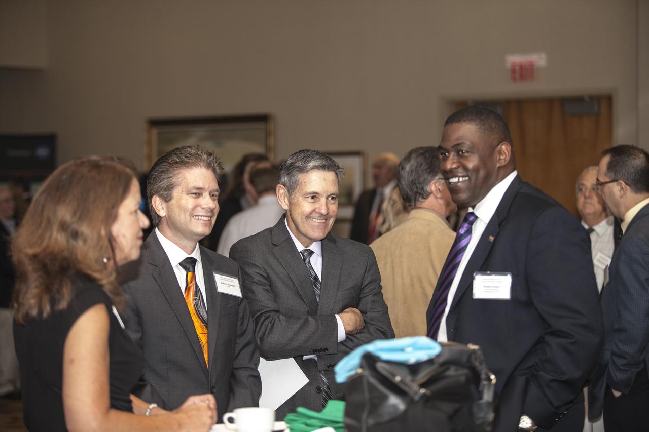 CAPE CANAVERAL, Fla. - NASA Kennedy Space Center Director Robert Cabana, second from right, welcomes community leaders, business executives, educators, community organizers, and state and local government leaders to the Kennedy Space Center Visitor Complex Debus Center for the Kennedy Space Center Director Update. At far right is Brevard County District 1 Commissioner Robin Fisher. Attendees talked with Cabana and other senior Kennedy managers and visited displays featuring updates on Kennedy programs and projects, including International Space Station, Commercial Crew, Ground System Development and Operations, Launch Services, Center Planning and Development, Technology, KSC Swamp Works and NASA Education. The morning concluded with a tour of the new Space Shuttle Atlantis exhibit at the visitor complex. For more information, visit http://www.nasa.gov/kennedy. Photo credit: NASA/Daniel Casper
