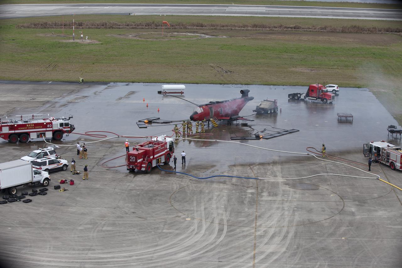 CAPE CANAVERAL, Fla. - Special Rescue Operations firefighters with NASA Fire Rescue Services in the Protective Services Office at NASA’s Kennedy Space Center in Florida participate in a training exercise at the Shuttle Landing Facility. Firefighters use fire trucks and hoses to extinguish flames burning on and around a mock-up of a small plane. Kennedy’s firefighters recently achieved Pro Board Certification in aerial fire truck operations and completed vehicle extrication training using the Jaws of Life. The Protective Services Office is one step closer to achieving certification in vehicle machinery extrication and other rescue skills. Kennedy’s firefighters are with G4S Government Solutions Inc., on the Kennedy Protective Services Contract. Photo credit: NASA/Kim Shiflett