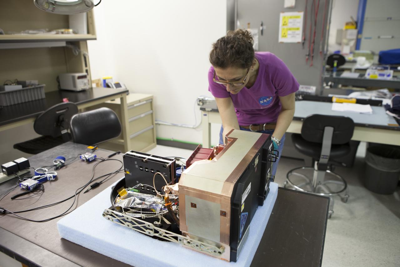 CAPE CANAVERAL, Fla. - In the Space Station Processing Facility at NASA's Kennedy Space Center in Florida, QinetiQ North America Project Manager Carole Miller prepares the Biotube experiment which will be launched to the International Space Station aboard a SpaceX Dragon spacecraft. Scheduled for launch on March 16 atop a Falcon 9 rocket, Dragon will be marking its fourth trip to the space station. The SpaceX-3 mission is the third of 12 flights contracted by NASA to resupply the orbiting laboratory. For more information, visit http://www.nasa.gov/mission_pages/station/structure/launch/index.html Photo credit: NASA/Kim Shiflett