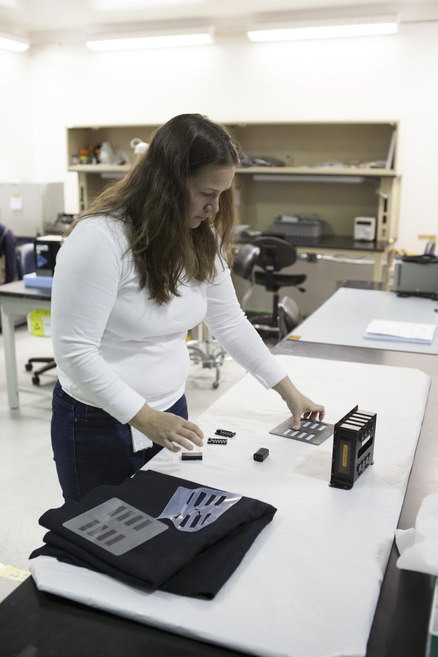 CAPE CANAVERAL, Fla. - In the Space Station Processing Facility at NASA's Kennedy Space Center in Florida, Allison Caron, a QinetiQ mechanical engineer, checks out part of the Biotube experiment which will be launched to the International Space Station aboard a SpaceX Dragon spacecraft. Scheduled for launch on March 16 atop a Falcon 9 rocket, Dragon will be marking its fourth trip to the space station. The SpaceX-3 mission is the third of 12 flights contracted by NASA to resupply the orbiting laboratory. For more information, visit http://www.nasa.gov/mission_pages/station/structure/launch/index.html Photo credit: NASA/Kim Shiflett