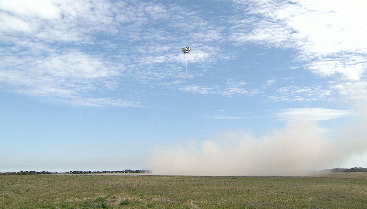 CAPE CANAVERAL, Fla. - The Project Morpheus prototype lander soars high on its seventh free flight test at the north end of the Shuttle Landing Facility at NASA’s Kennedy Space Center in Florida. The 83-second test began at 3:41 p.m. EDT with the Morpheus lander launching from the ground over a flame trench and ascending to 580 feet, its highest to date. Morpheus then flew its fastest downrange trek at 30 mph, travelling farther than before, 837 feet. The lander performed a 42-foot divert to emulate a hazard avoidance maneuver before descending and touching down on Landing Site 2, at the northern landing pad inside the automated landing and hazard avoidance technology ALHAT hazard field. Morpheus landed within one foot of its intended target. Project Morpheus tests NASA’s ALHAT and an engine that runs on liquid oxygen and methane, or green propellants, into a fully-operational lander that could deliver cargo to other planetary surfaces. The landing facility provides the lander with the kind of field necessary for realistic testing, complete with rocks, craters and hazards to avoid. Morpheus’ ALHAT payload allows it to navigate to clear landing sites amidst rocks, craters and other hazards during its descent. Project Morpheus is being managed under the Advanced Exploration Systems, or AES, Division in NASA’s Human Exploration and Operations Mission Directorate. The efforts in AES pioneer new approaches for rapidly developing prototype systems, demonstrating key capabilities and validating operational concepts for future human missions beyond Earth orbit. For more information on Project Morpheus, visit http://morpheuslander.jsc.nasa.gov/. Photo credit: NASA/Mike Chambers