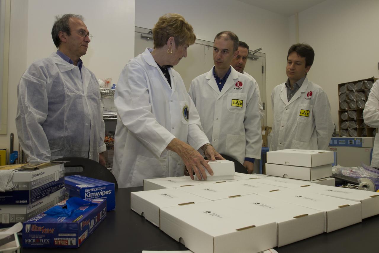 CAPE CANAVERAL, Fla. - Researcher and former NASA payload specialist Millie Hughes-Fulford, of the Hughes-Fulford Laboratory, San Francisco, Calif., accepts the European Space Agency ESA T-cell experiment flight units being handed over in a Space Station Processing Facility laboratory at NASA's Kennedy Space Center in Florida. From left are Raimondo Fortezza of ESA, Hughes-Fulford, and Pier Luigi Ganga, Marco Vukich and Fabio Creati of Kayser Italia, manufacturer of the hardware. The immunology experiment will launch on SpaceX-3 and focus on the effects of microgravity on early T-cell signaling pathways. Current work aims to identify and compare the gene expression of microRNAs miRNAs during T-cell activation under normal gravity and in microgravity, and compare those patterns to changes seen in aging populations. The experiment will be the first flown on SpaceX funded by the National Institutes of Health. Dr. Hughes-Fulford flew aboard space shuttle mission STS-40 in June 1991, the first Spacelab mission dedicated to biomedical studies. For more information on the T-cell experiment, visit http://hughesfulfordlab.com and http://www.nasa.gov/ames/research/space-biosciences/t-cell-activation-in-aging-spacex-3/. Photo credit: NASA/Cory Huston