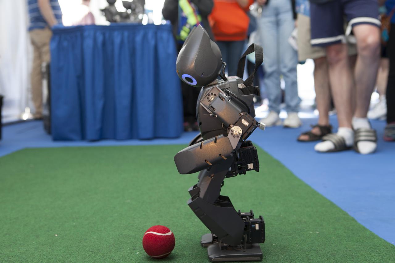 CAPE CANAVERAL, Fla. – A miniature humanoid robot known as DARwin-OP, from Virginia Tech Robotics, plays soccer with a red tennis ball for a crowd of students at the Robot Rocket Rally. The three-day event at Florida's Kennedy Space Center Visitor Complex is highlighted by exhibits, games and demonstrations of a variety of robots, with exhibitors ranging from school robotics clubs to veteran NASA scientists and engineers. Photo credit: NASA/Kim Shiflett
