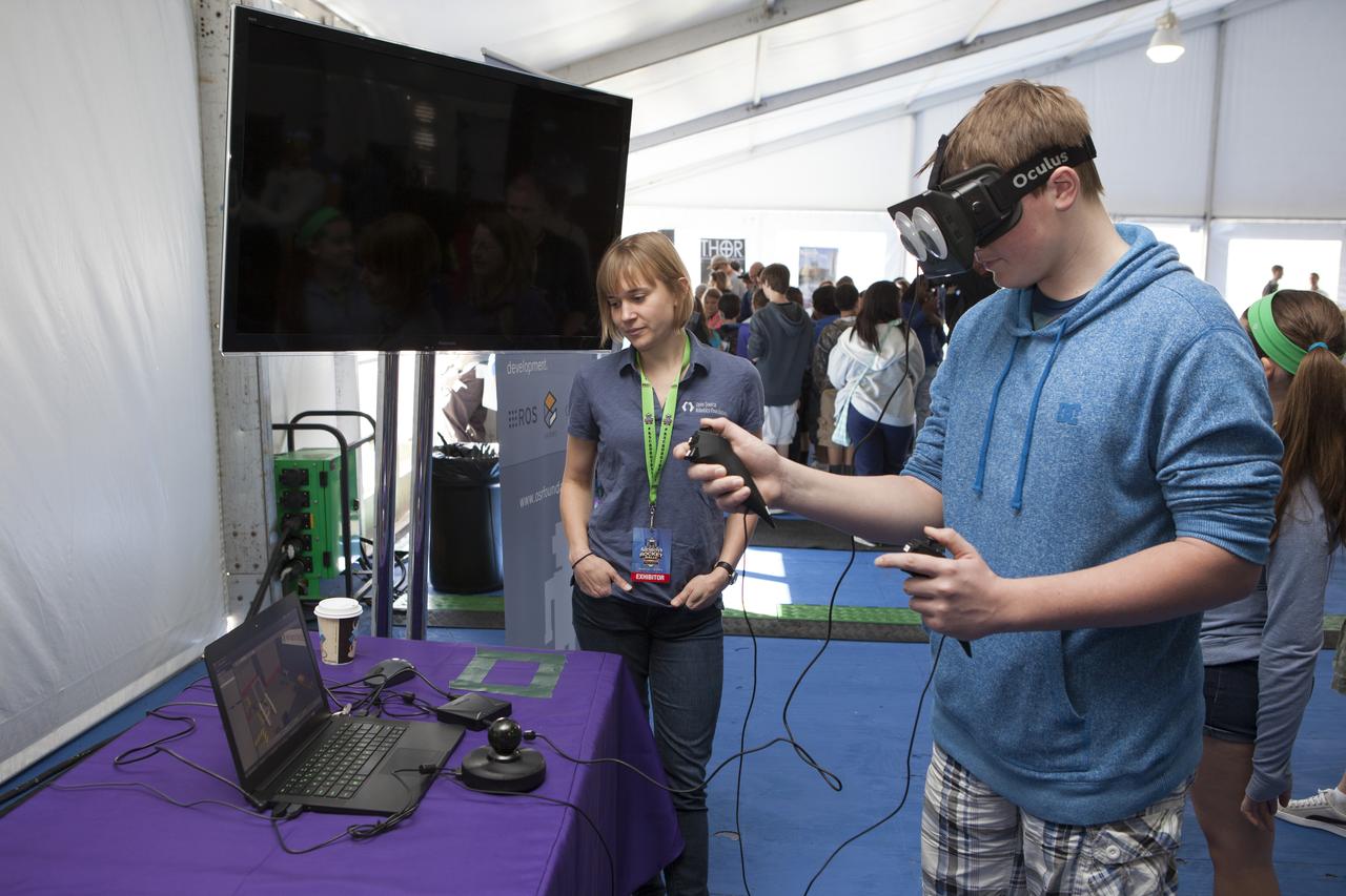 CAPE CANAVERAL, Fla. – A visitor to the Robot Rocket Rally tries his hand at virtual reality in a demonstration of the Oculus Rift technology, provided by the Open Source Robotics Foundation. The three-day event at Florida's Kennedy Space Center Visitor Complex is highlighted by exhibits, games and demonstrations of a variety of robots, with exhibitors ranging from school robotics clubs to veteran NASA scientists and engineers. Photo credit: NASA/Kim Shiflett