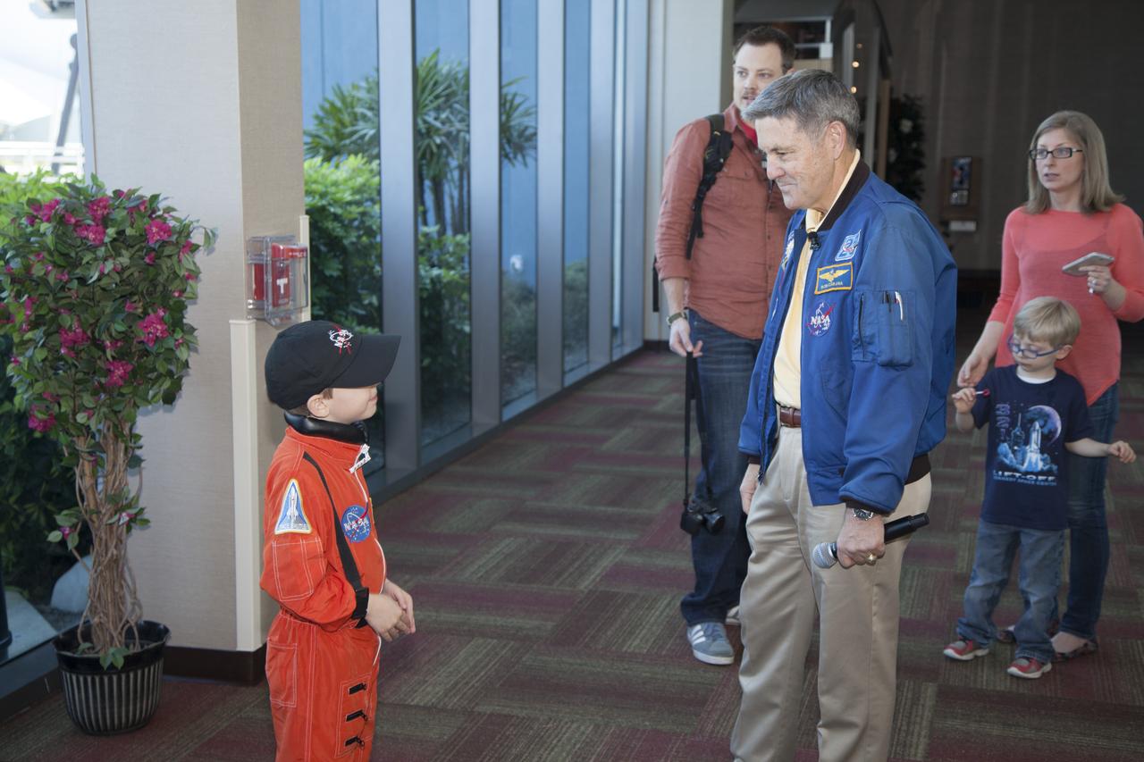 CAPE CANAVERAL, Fla. – Six-year-old Connor Johnson, left, is welcomed to the Kennedy Space Center Visitor Complex in Florida by NASA Kennedy Space Center Director and former astronaut Robert Cabana for a ceremony in which he will present Connor with space mementos to inspire the youngster to continue the dream he has had since the age of three of becoming an astronaut. Connor is accompanied by his parents Eric and Lauren and younger brother Liam, in the background. Connor, of Denver, Colo., gained national attention for having the "right stuff" when he launched an online petition on the White House website in December 2013 to save NASA’s funding from budget cuts. One of the mementos, a piece of space history, was a bolt used to hold the International Space Station's Unity module in place in space shuttle Endeavour's payload bay on the STS-88 mission, the first station assembly mission and Cabana's fourth and final spaceflight. Connor and his family were the guests of Delaware North Companies Parks & Resorts, the concessionaire managing the visitor complex. During his visit, Connor had the opportunity to meet with astronauts, see space vehicles and witness the Robot Rocket Rally underway in the complex' Rocket Garden over the weekend. To learn more about the educational activities available daily at the Kennedy Space Center Visitor Complex, visit http://www.kennedyspacecenter.com. Photo credit: NASA/Dan Casper