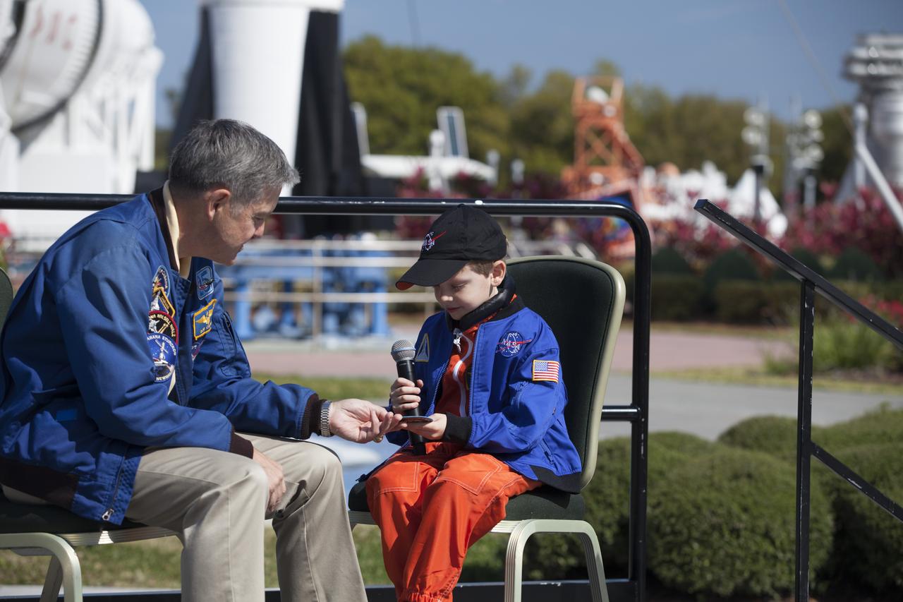 CAPE CANAVERAL, Fla. – NASA Kennedy Space Center Director and former astronaut Robert Cabana, left, presents a space patch and other mementos to six-year-old Connor Johnson at the Kennedy Space Center Visitor Complex' Rocket Garden to inspire the youngster to continue the dream he has had since the age of three of becoming an astronaut. Connor, of Denver, Colo., gained national attention for having the "right stuff" when he launched an online petition on the White House website in December 2013 to save NASA’s funding from budget cuts. One of the mementos, a piece of space history, was a bolt used to hold the International Space Station's Unity module in place in space shuttle Endeavour's payload bay on the STS-88 mission, the first station assembly mission and Cabana's fourth and final spaceflight. Connor and his family were the guests of Delaware North Companies Parks & Resorts, the concessionaire managing the visitor complex. During his visit, Connor had the opportunity to meet with astronauts, see space vehicles and witness the Robot Rocket Rally underway in the complex' Rocket Garden over the weekend. To learn more about the educational activities available daily at the Kennedy Space Center Visitor Complex, visit http://www.kennedyspacecenter.com. Photo credit: NASA/Dan Casper