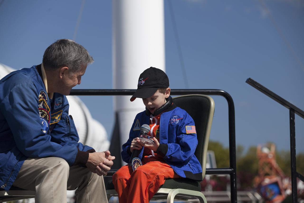 CAPE CANAVERAL, Fla. – Six-year-old Connor Johnson, right, show his delight at being presented with space mementos to inspire the youngster to continue the dream he has had since the age of three of becoming an astronaut, by NASA Kennedy Space Center Director and former astronaut Robert Cabana in the Kennedy Space Center Visitor Complex' Rocket Garden. Connor, of Denver, Colo., gained national attention for having the "right stuff" when he launched an online petition on the White House website in December 2013 to save NASA’s funding from budget cuts. One of the mementos, a piece of space history, was a bolt used to hold the International Space Station's Unity module in place in space shuttle Endeavour's payload bay on the STS-88 mission, the first station assembly mission and Cabana's fourth and final spaceflight. Connor and his family were the guests of Delaware North Companies Parks & Resorts, the concessionaire managing the visitor complex. During his visit, Connor had the opportunity to meet with astronauts, see space vehicles and witness the Robot Rocket Rally underway in the complex' Rocket Garden over the weekend. To learn more about the educational activities available daily at the Kennedy Space Center Visitor Complex, visit http://www.kennedyspacecenter.com. Photo credit: NASA/Dan Casper