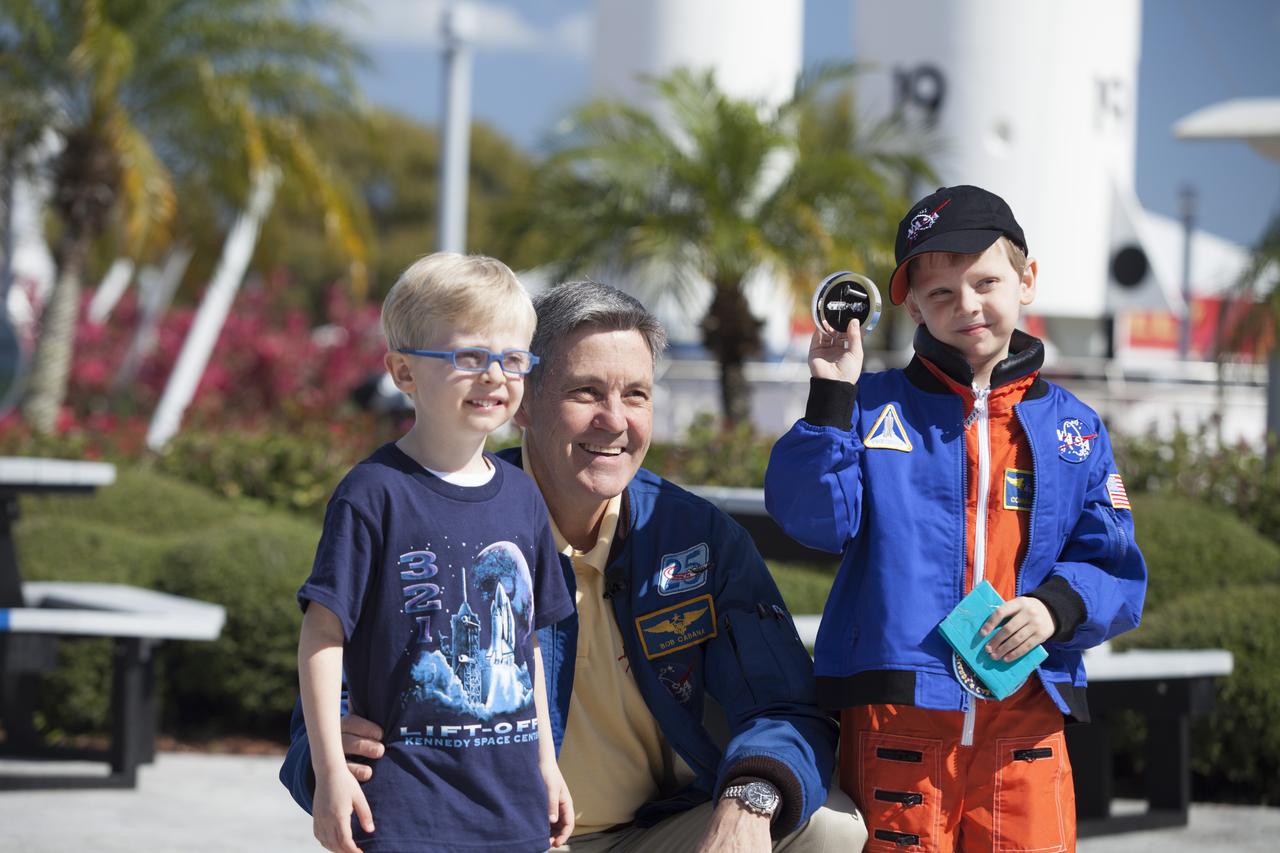 CAPE CANAVERAL, Fla. – Six-year-old Connor Johnson shows off space mementos presented to him by Kennedy Space Center Director and former astronaut Robert Cabana to inspire the youngster to continue the dream he has had since the age of three of becoming an astronaut, following a ceremony in the Kennedy Space Center Visitor Complex' Rocket Garden. From left are Connor's brother Liam, Cabana and Connor. Connor, of Denver, Colo., gained national attention for having the "right stuff" when he launched an online petition on the White House website in December 2013 to save NASA’s funding from budget cuts. One of the mementos, a piece of space history, was a bolt used to hold the International Space Station's Unity module in place in space shuttle Endeavour's payload bay on the STS-88 mission, the first station assembly mission and Cabana's fourth and final spaceflight. Connor and his family were the guests of Delaware North Companies Parks & Resorts, the concessionaire managing the visitor complex. During his visit, Connor had the opportunity to meet with astronauts, see space vehicles and witness the Robot Rocket Rally underway in the complex' Rocket Garden over the weekend. To learn more about the educational activities available daily at the Kennedy Space Center Visitor Complex, visit http://www.kennedyspacecenter.com. Photo credit: NASA/Dan Casper