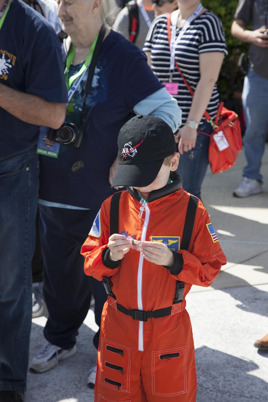CAPE CANAVERAL, Fla. – Six-year-old Connor Johnson examines one of the space mementos presented to him by Kennedy Space Center Director and former astronaut Robert Cabana to inspire the youngster to continue the dream he has had since the age of three of becoming an astronaut, following a ceremony in the Kennedy Space Center Visitor Complex' Rocket Garden. Connor, of Denver, Colo., gained national attention for having the "right stuff" when he launched an online petition on the White House website in December 2013 to save NASA’s funding from budget cuts. One of the mementos, a piece of space history, was a bolt used to hold the International Space Station's Unity module in place in space shuttle Endeavour's payload bay on the STS-88 mission, the first station assembly mission and Cabana's fourth and final spaceflight. Connor and his family were the guests of Delaware North Companies Parks & Resorts, the concessionaire managing the visitor complex. During his visit, Connor had the opportunity to meet with astronauts, see space vehicles and witness the Robot Rocket Rally underway in the complex' Rocket Garden over the weekend. To learn more about the educational activities available daily at the Kennedy Space Center Visitor Complex, visit http://www.kennedyspacecenter.com. Photo credit: NASA/Dan Casper