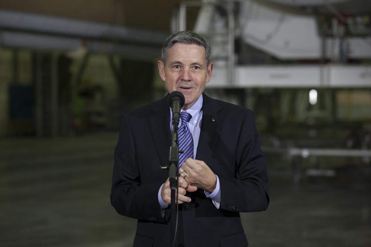 CAPE CANAVERAL, Fla. – During a media event inside the Horizontal Integration Facility at Launch Complex 37 at Cape Canaveral Air Force Station in Florida, Kennedy Space Center Director Bob Cabana speaks to members of the media. Behind him are two of the United Launch Alliance Delta IV boosters for the Orion Exploration Flight Test-1, or EFT-1, mission. Orion is the exploration spacecraft designed to carry astronauts to destinations not yet explored by humans, including an asteroid and Mars. It will have emergency abort capability, sustain the crew during space travel and provide safe re-entry from deep space return velocities. The first unpiloted test flight of Orion, EFT-1, is scheduled to launch in 2014 atop a Delta IV rocket and in 2017 on NASA’s Space Launch System rocket. For more information, visit http://www.nasa.gov/orion. Photo credit: NASA/Kim Shiflett