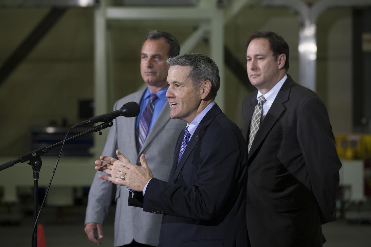CAPE CANAVERAL, Fla. – During a media event inside the Horizontal Integration Facility at Launch Complex 37 at Cape Canaveral Air Force Station in Florida, Kennedy Space Center Director Bob Cabana speaks to members of the media. To his left is Tony Taliancich, director of East Coast Launch Operations with United Launch Alliance, or ULA. To the right is NASA Associate Administrator Robert Lightfoot. The event was held to showcase two of the ULA Delta IV boosters for the Orion Exploration Flight Test-1, or EFT-1, mission. Orion is the exploration spacecraft designed to carry astronauts to destinations not yet explored by humans, including an asteroid and Mars. It will have emergency abort capability, sustain the crew during space travel and provide safe re-entry from deep space return velocities. The first unpiloted test flight of Orion, EFT-1, is scheduled to launch in 2014 atop a Delta IV rocket and in 2017 on NASA’s Space Launch System rocket. For more information, visit http://www.nasa.gov/orion. Photo credit: NASA/Kim Shiflett
