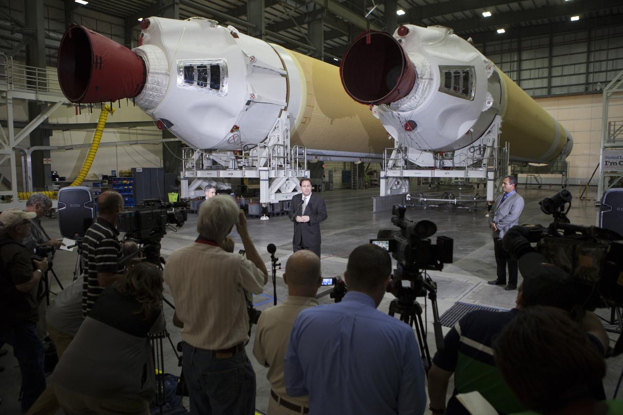 CAPE CANAVERAL, Fla. – During a media event inside the Horizontal Integration Facility at Launch Complex 37 at Cape Canaveral Air Force Station in Florida, NASA Associate Administrator Robert Lightfoot answers questions. To his right is Tony Taliancich, director of East Coast Launch Operations with United Launch Alliance, or ULA. Also participating in the event was Kennedy Space Center Director Bob Cabana. The event was held to showcase two of the ULA Delta IV boosters for the Orion Exploration Flight Test-1, or EFT-1, mission. Orion is the exploration spacecraft designed to carry astronauts to destinations not yet explored by humans, including an asteroid and Mars. It will have emergency abort capability, sustain the crew during space travel and provide safe re-entry from deep space return velocities. The first unpiloted test flight of Orion, EFT-1, is scheduled to launch in 2014 atop a Delta IV rocket and in 2017 on NASA’s Space Launch System rocket. For more information, visit http://www.nasa.gov/orion. Photo credit: NASA/Kim Shiflett