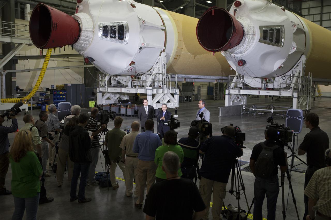 CAPE CANAVERAL, Fla. – During a media event inside the Horizontal Integration Facility at Launch Complex 37 at Cape Canaveral Air Force Station in Florida, Kennedy Space Center Director Bob Cabana speaks to members of the media. To his right is Tony Taliancich, director of East Coast Launch Operations with United Launch Alliance, or ULA. To his left is NASA Associate Administrator Robert Lightfoot. The event was held to showcase two of the ULA Delta IV boosters for the Orion Exploration Flight Test-1, or EFT-1, mission. Orion is the exploration spacecraft designed to carry astronauts to destinations not yet explored by humans, including an asteroid and Mars. It will have emergency abort capability, sustain the crew during space travel and provide safe re-entry from deep space return velocities. The first unpiloted test flight of Orion, EFT-1, is scheduled to launch in 2014 atop a Delta IV rocket and in 2017 on NASA’s Space Launch System rocket. For more information, visit http://www.nasa.gov/orion. Photo credit: NASA/Kim Shiflett