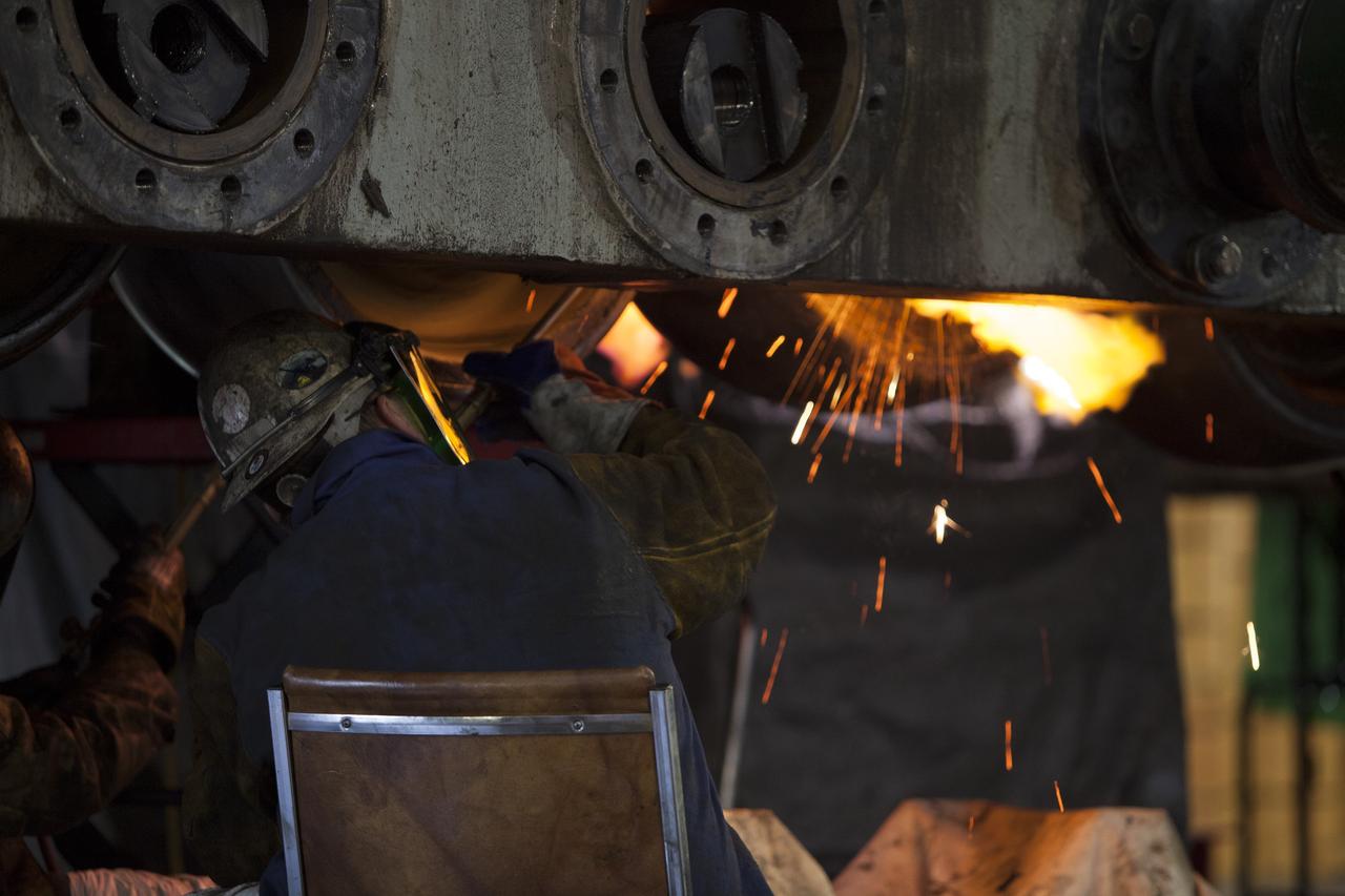 CAPE CANAVERAL, Fla. – Inside the Vehicle Assembly Building at NASA’s Kennedy Space Center in Florida, a ground support technician applies heat to a casing that contains an old  bearing on the B truck tread of crawler-transporter 2, or CT-2. The bearing will separate and out for removal. New roller bearing assemblies will be installed on CT-2.    Work continues in high bay 2 to upgrade CT-2. The modifications are designed to ensure CT-2’s ability to transport launch vehicles currently in development, such as the agency’s Space Launch System, to the launch pad. The Ground Systems Development and Operations Program office at Kennedy is overseeing the upgrades. For more than 45 years the crawler-transporters were used to transport the mobile launcher platform and the Apollo-Saturn V rockets and, later, space shuttles to Launch Pads 39A and B. For more information, visit: http://www.nasa.gov/exploration/systems/ground/crawler-transporter. Photo credit: NASA/Dimitri Gerondidakis