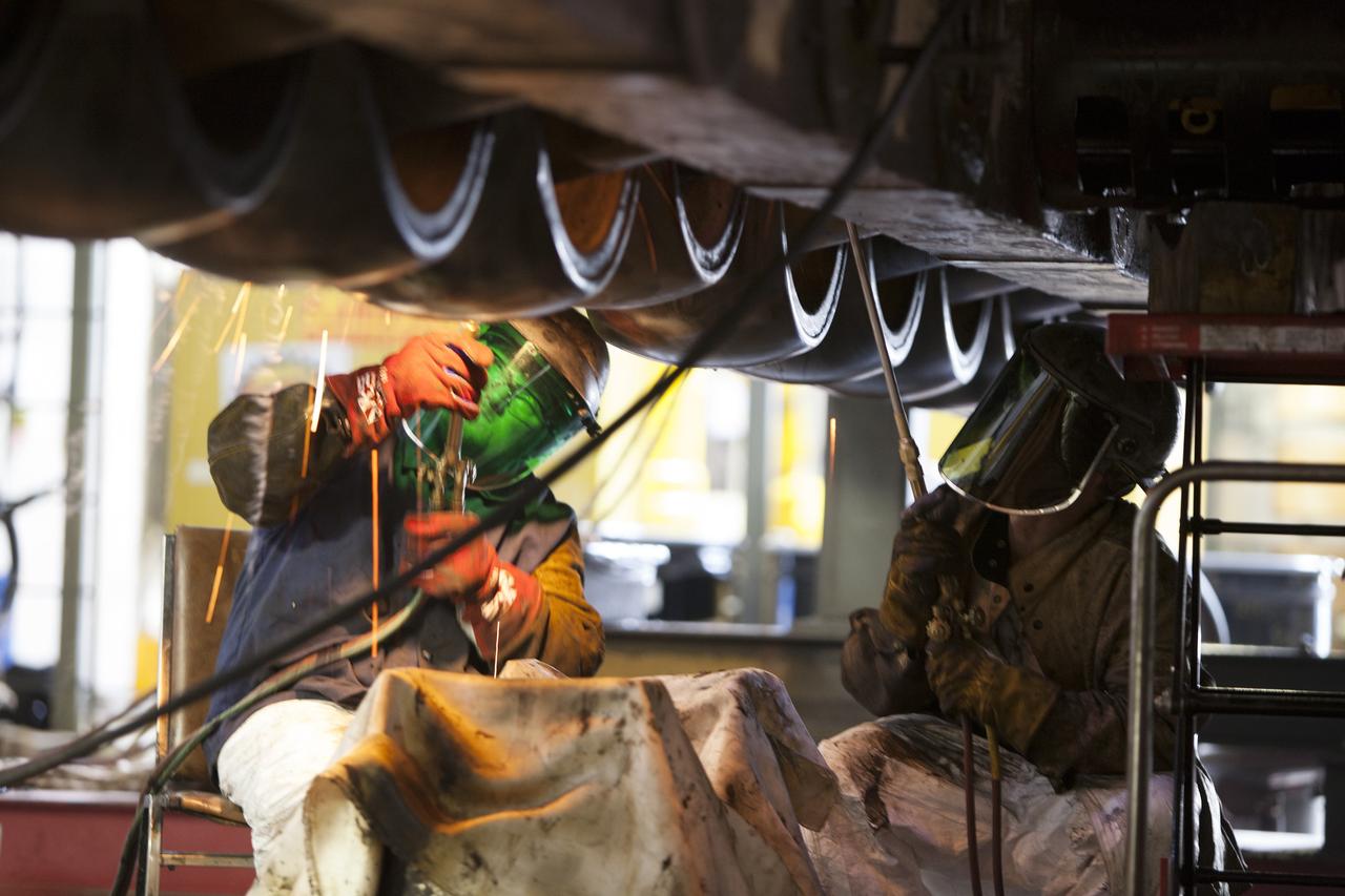 CAPE CANAVERAL, Fla. – Inside the Vehicle Assembly Building at NASA’s Kennedy Space Center in Florida, ground support technicians apply heat to a casing that contains an old  bearing on the B truck tread of crawler-transporter 2, or CT-2. The bearing will separate and out for removal. New roller bearing assemblies will be installed on CT-2.    Work continues in high bay 2 to upgrade CT-2. The modifications are designed to ensure CT-2’s ability to transport launch vehicles currently in development, such as the agency’s Space Launch System, to the launch pad. The Ground Systems Development and Operations Program office at Kennedy is overseeing the upgrades. For more than 45 years the crawler-transporters were used to transport the mobile launcher platform and the Apollo-Saturn V rockets and, later, space shuttles to Launch Pads 39A and B. For more information, visit: http://www.nasa.gov/exploration/systems/ground/crawler-transporter. Photo credit: NASA/Dimitri Gerondidakis