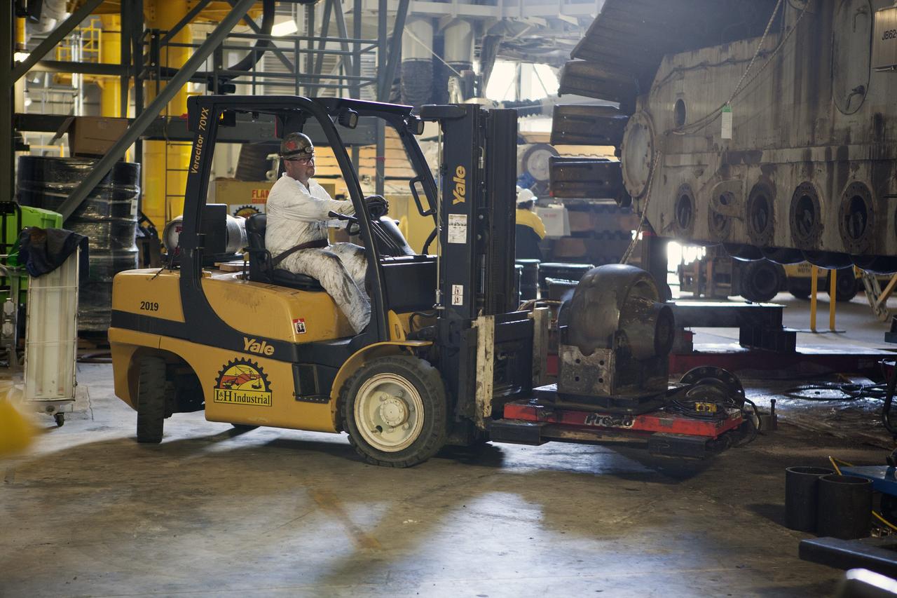 CAPE CANAVERAL, Fla. – Inside the Vehicle Assembly Building at NASA’s Kennedy Space Center in Florida, an old bearing has been removed from the B truck tread of crawler-transporter 2, or CT-2, and loaded onto a forklift for disposal. New roller bearing assemblies will be installed.    Work continues in high bay 2 to upgrade CT-2. The modifications are designed to ensure CT-2’s ability to transport launch vehicles currently in development, such as the agency’s Space Launch System, to the launch pad. The Ground Systems Development and Operations Program office at Kennedy is overseeing the upgrades. For more than 45 years the crawler-transporters were used to transport the mobile launcher platform and the Apollo-Saturn V rockets and, later, space shuttles to Launch Pads 39A and B. For more information, visit: http://www.nasa.gov/exploration/systems/ground/crawler-transporter. Photo credit: NASA/Dimitri Gerondidakis