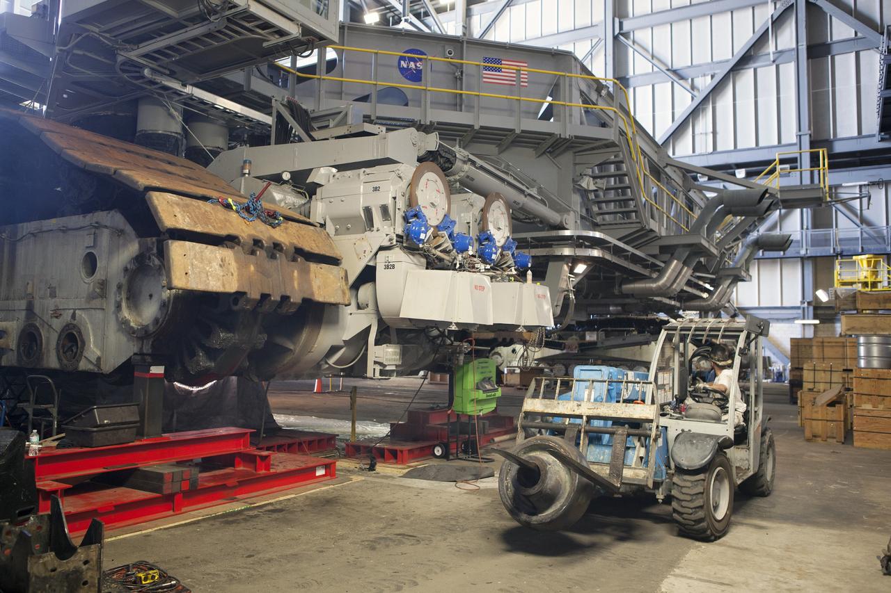CAPE CANAVERAL, Fla. – Inside the Vehicle Assembly Building at NASA’s Kennedy Space Center in Florida, an old bearing has been removed from the B truck tread of crawler-transporter 2, or CT-2, and loaded onto a forklift for disposal. New roller bearing assemblies will be installed.    Work continues in high bay 2 to upgrade CT-2. The modifications are designed to ensure CT-2’s ability to transport launch vehicles currently in development, such as the agency’s Space Launch System, to the launch pad. The Ground Systems Development and Operations Program office at Kennedy is overseeing the upgrades. For more than 45 years the crawler-transporters were used to transport the mobile launcher platform and the Apollo-Saturn V rockets and, later, space shuttles to Launch Pads 39A and B. For more information, visit: http://www.nasa.gov/exploration/systems/ground/crawler-transporter. Photo credit: NASA/Dimitri Gerondidakis
