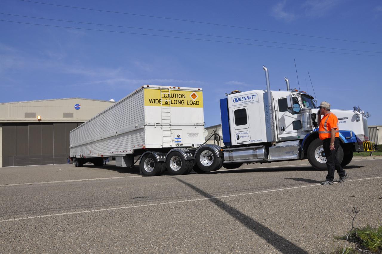 VANDENBERG AIR FORCE BASE, Calif. – The truck transporting the Delta first-stage booster for NASA's Orbiting Carbon Observatory-2 mission, or OCO-2, backs toward the Building 836 hangar at Space Launch Complex 2 on Vandenberg Air Force Base in California. OCO-2 is scheduled to launch aboard a United Launch Alliance Delta II rocket in July. The observatory will collect precise global measurements of carbon dioxide in the Earth's atmosphere and provide scientists with a better idea of the chemical compound's impacts on climate change. Scientists will analyze this data to improve our understanding of the natural processes and human activities that regulate the abundance and distribution of this important atmospheric gas. To learn more about OCO-2, visit http://oco.jpl.nasa.gov. Photo credit: NASA/Randy Beaudoin