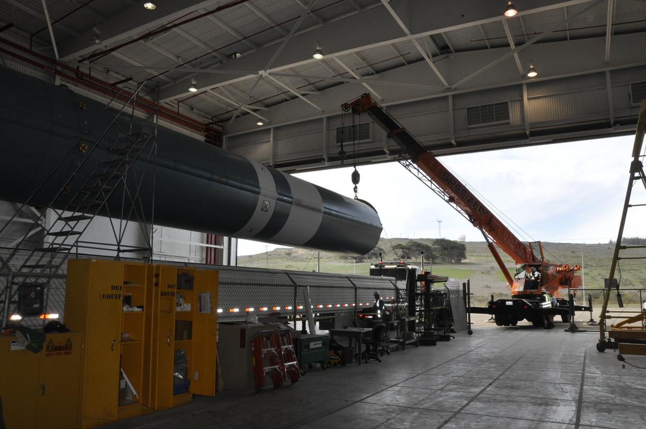 VANDENBERG AIR FORCE BASE, Calif. – The Delta first-stage booster for NASA's Orbiting Carbon Observatory-2 mission, or OCO-2, is suspended above its transportation trailer in the Building 836 hangar at Space Launch Complex 2 on Vandenberg Air Force Base in California. OCO-2 is scheduled to launch aboard a United Launch Alliance Delta II rocket in July. The observatory will collect precise global measurements of carbon dioxide in the Earth's atmosphere and provide scientists with a better idea of the chemical compound's impacts on climate change. Scientists will analyze this data to improve our understanding of the natural processes and human activities that regulate the abundance and distribution of this important atmospheric gas. To learn more about OCO-2, visit http://oco.jpl.nasa.gov. Photo credit: NASA/Randy Beaudoin