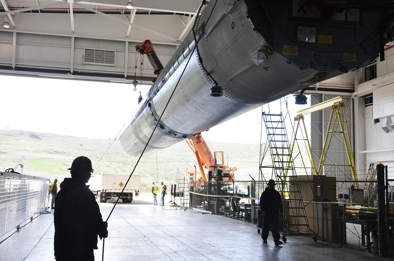 VANDENBERG AIR FORCE BASE, Calif. – The Delta first-stage booster for NASA's Orbiting Carbon Observatory-2 mission, or OCO-2, is transferred from its transportation trailer to a transportation hardware cradle in the Building 836 hangar at Space Launch Complex 2 on Vandenberg Air Force Base in California.      OCO-2 is scheduled to launch aboard a United Launch Alliance Delta II rocket in July.  The observatory will collect precise global measurements of carbon dioxide in the Earth's atmosphere and provide scientists with a better idea of the chemical compound's impacts on climate change. Scientists will analyze this data to improve our understanding of the natural processes and human activities that regulate the abundance and distribution of this important atmospheric gas. To learn more about OCO-2, visit http://oco.jpl.nasa.gov.  Photo credit: NASA/Randy Beaudoin