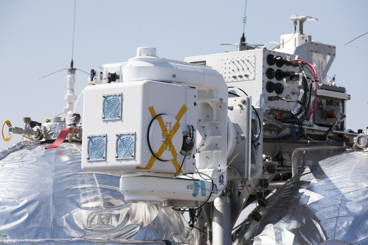 CAPE CANAVERAL, Fla. – Engineers run an automated landing and hazard avoidance technology, or ALHAT, and laser test on the Project Morpheus prototype lander at a new launch site at the north end of the Shuttle Landing Facility at NASA’s Kennedy Space Center in Florida. The launch pad was moved to a different location at the landing facility to support the next phase of flight testing. The seventh free flight test of Morpheus occurred on March 11. The 83-second test began at 3:41 p.m. EDT with the Morpheus lander launching from the ground over a flame trench and ascending to 580 feet. Morpheus then flew its fastest downrange trek at 30 mph, travelling farther than before, 837 feet. The lander performed a 42-foot divert to emulate a hazard avoidance maneuver before descending and touching down on Landing Site 2, at the northern landing pad inside the ALHAT hazard field. Morpheus landed within one foot of its intended target. Project Morpheus tests NASA’s ALHAT and an engine that runs on liquid oxygen and methane, or green propellants, into a fully-operational lander that could deliver cargo to other planetary surfaces. The landing facility provides the lander with the kind of field necessary for realistic testing, complete with rocks, craters and hazards to avoid. Morpheus’ ALHAT payload allows it to navigate to clear landing sites amidst rocks, craters and other hazards during its descent. Project Morpheus is being managed under the Advanced Exploration Systems, or AES, Division in NASA’s Human Exploration and Operations Mission Directorate. The efforts in AES pioneer new approaches for rapidly developing prototype systems, demonstrating key capabilities and validating operational concepts for future human missions beyond Earth orbit. For more information on Project Morpheus, visit http://morpheuslander.jsc.nasa.gov/. Photo credit: NASA/Kim Shiflett