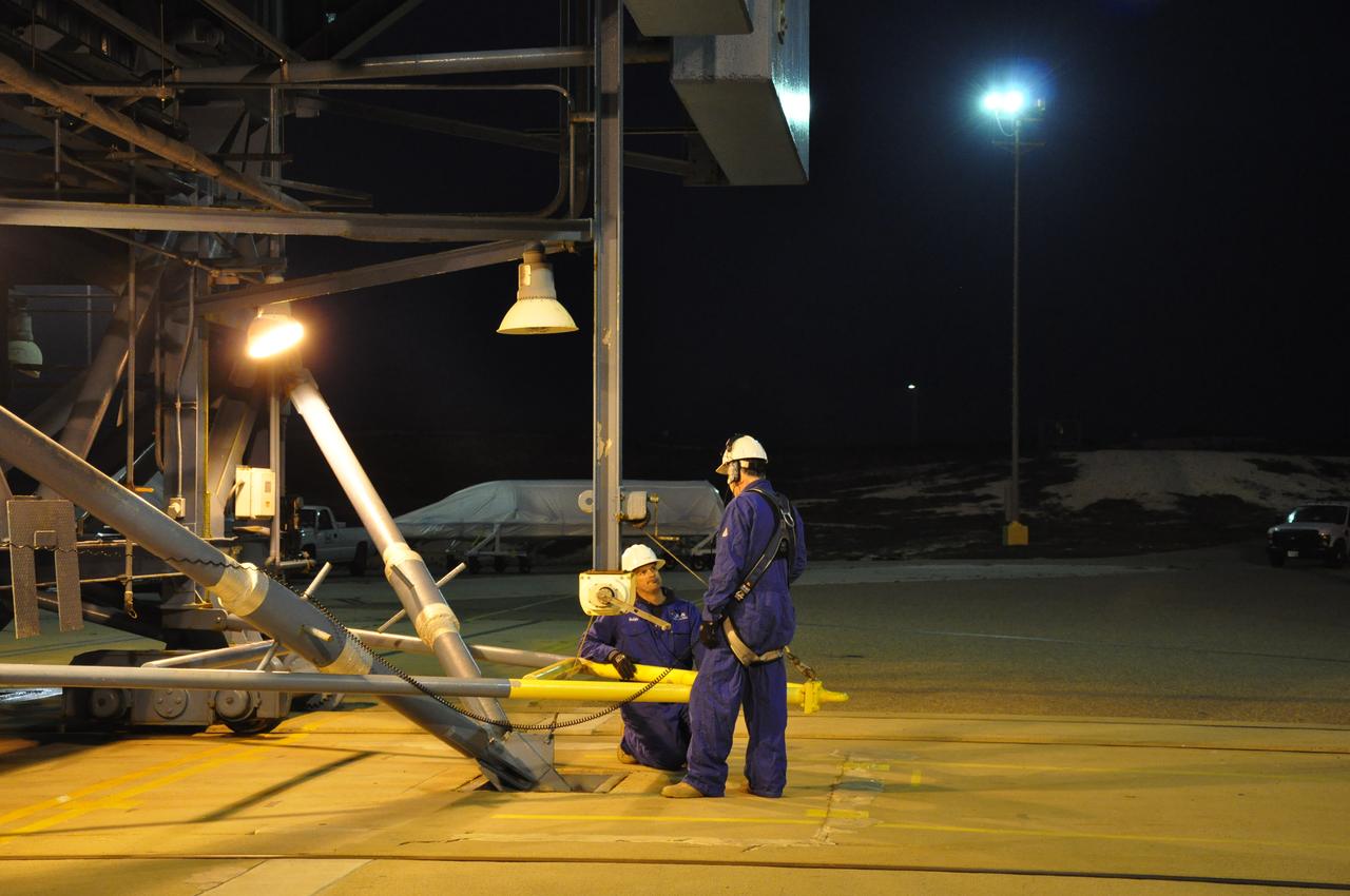 VANDENBERG AIR FORCE BASE, Calif. – At Space Launch Complex 2 on Vandenberg Air Force Base in California, workers prepare to hoist the fairing for NASA's Orbiting Carbon Observatory-2 mission, or OCO-2, seen in the background, into the gantry's environmental enclosure, or clean room, following the rollback of the mobile service tower. The fairing will protect OCO-2 during launch aboard a United Launch Alliance Delta II rocket from Space Launch Complex 2 in July. The observatory will collect precise global measurements of carbon dioxide in the Earth's atmosphere and provide scientists with a better idea of the chemical compound's impacts on climate change. Scientists will analyze this data to improve our understanding of the natural processes and human activities that regulate the abundance and distribution of this important atmospheric gas. To learn more about OCO-2, visit http://oco.jpl.nasa.gov. Photo credit: NASA/Randy Beaudoin