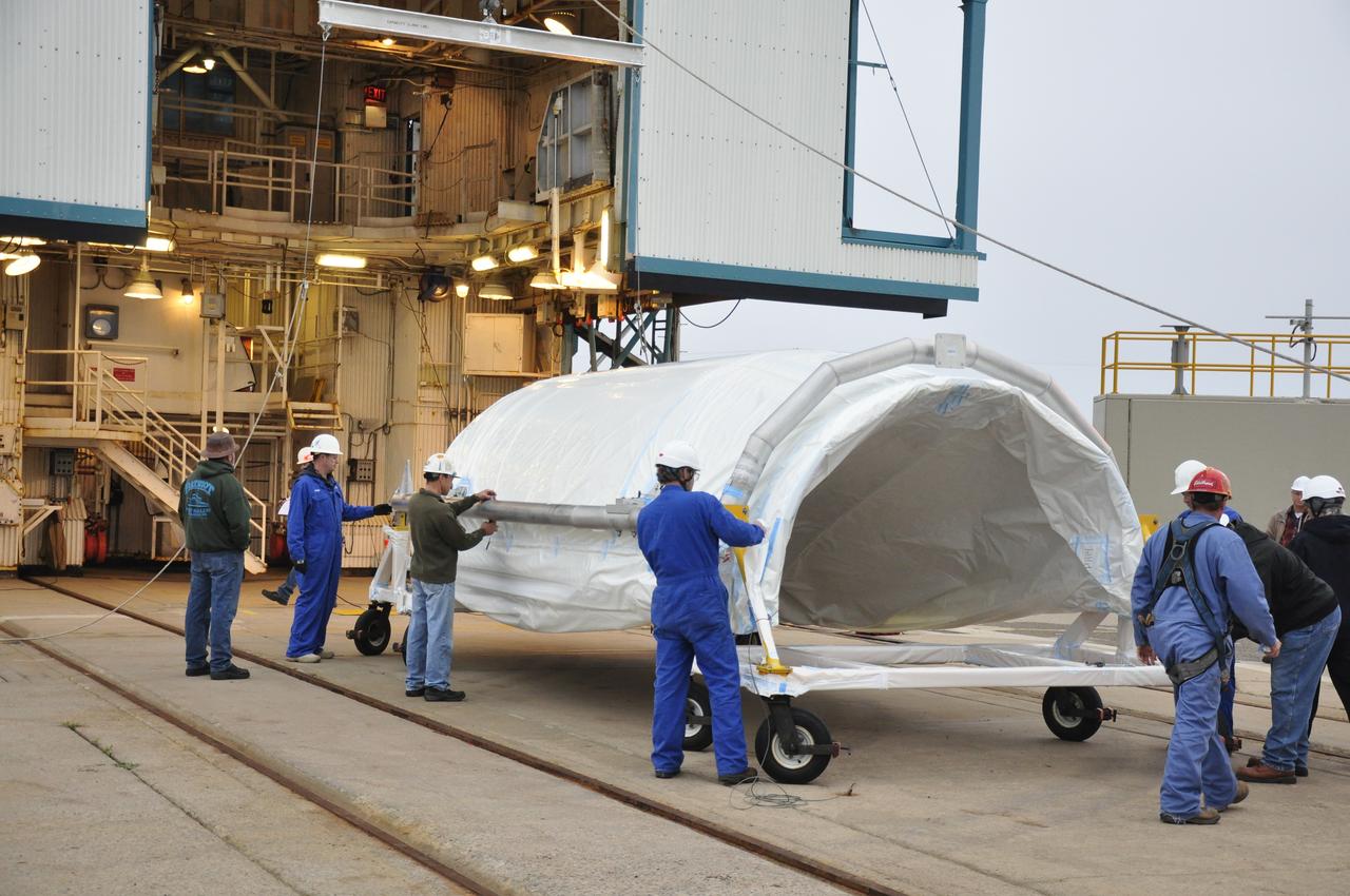 VANDENBERG AIR FORCE BASE, Calif. – Workers remove the protective wrap from half of the fairing for NASA's Orbiting Carbon Observatory-2 mission, or OCO-2, newly arrived at Space Launch Complex 2 on Vandenberg Air Force Base in California. Operations are underway to hoist this section of the fairing into the Delta II launcher's environmental enclosure, or clean room, at the top of the tower. The fairing will protect OCO-2 during launch aboard a United Launch Alliance Delta II rocket from Space Launch Complex 2 in July. The observatory will collect precise global measurements of carbon dioxide in the Earth's atmosphere and provide scientists with a better idea of the chemical compound's impacts on climate change. Scientists will analyze this data to improve our understanding of the natural processes and human activities that regulate the abundance and distribution of this important atmospheric gas. To learn more about OCO-2, visit http://oco.jpl.nasa.gov. Photo credit: NASA/Randy Beaudoin
