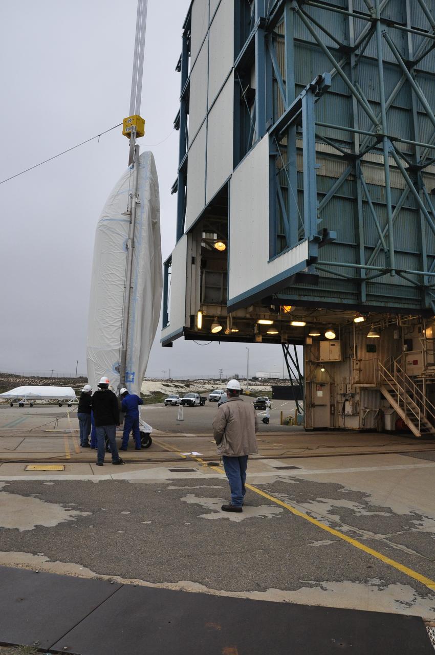 VANDENBERG AIR FORCE BASE, Calif. – A crane is employed to lift half of the fairing for NASA's Orbiting Carbon Observatory-2 mission, or OCO-2, into a vertical position at Space Launch Complex 2 on Vandenberg Air Force Base in California. Operations are underway to hoist this section of the fairing into the Delta II launcher's environmental enclosure, or clean room, at the top of the tower. The fairing will protect OCO-2 during launch aboard a United Launch Alliance Delta II rocket from Space Launch Complex 2 in July. The observatory will collect precise global measurements of carbon dioxide in the Earth's atmosphere and provide scientists with a better idea of the chemical compound's impacts on climate change. Scientists will analyze this data to improve our understanding of the natural processes and human activities that regulate the abundance and distribution of this important atmospheric gas. To learn more about OCO-2, visit http://oco.jpl.nasa.gov. Photo credit: NASA/Randy Beaudoin