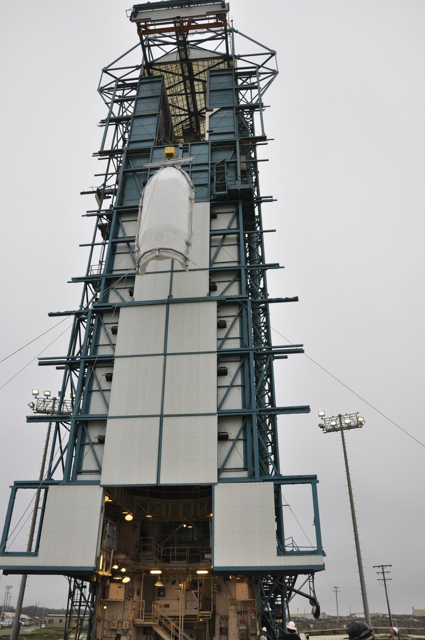 VANDENBERG AIR FORCE BASE, Calif. – Half of the fairing for NASA's Orbiting Carbon Observatory-2 mission, or OCO-2, is lifted toward the environmental enclosure, or clean room, at the top of the Delta II launcher at Space Launch Complex 2 on Vandenberg Air Force Base in California. The fairing will protect OCO-2 during launch aboard a United Launch Alliance Delta II rocket from Space Launch Complex 2 in July. The observatory will collect precise global measurements of carbon dioxide in the Earth's atmosphere and provide scientists with a better idea of the chemical compound's impacts on climate change. Scientists will analyze this data to improve our understanding of the natural processes and human activities that regulate the abundance and distribution of this important atmospheric gas. To learn more about OCO-2, visit http://oco.jpl.nasa.gov. Photo credit: NASA/Randy Beaudoin
