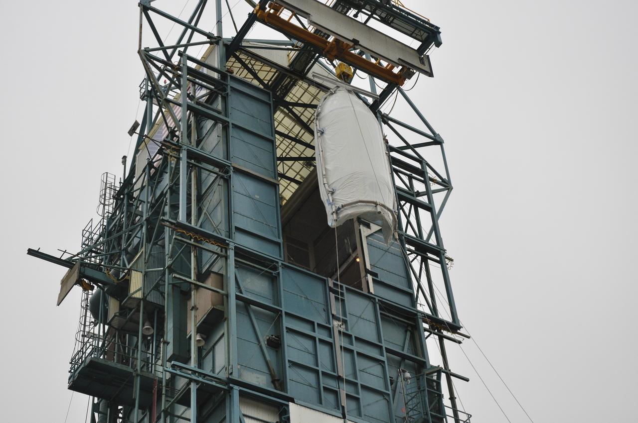 VANDENBERG AIR FORCE BASE, Calif. – Half of the fairing for NASA's Orbiting Carbon Observatory-2 mission, or OCO-2, arrives at the portal to the environmental enclosure, or clean room, at the top of the Delta II launcher at Space Launch Complex 2 on Vandenberg Air Force Base in California. The fairing will protect OCO-2 during launch aboard a United Launch Alliance Delta II rocket from Space Launch Complex 2 in July. The observatory will collect precise global measurements of carbon dioxide in the Earth's atmosphere and provide scientists with a better idea of the chemical compound's impacts on climate change. Scientists will analyze this data to improve our understanding of the natural processes and human activities that regulate the abundance and distribution of this important atmospheric gas. To learn more about OCO-2, visit http://oco.jpl.nasa.gov. Photo credit: NASA/Randy Beaudoin