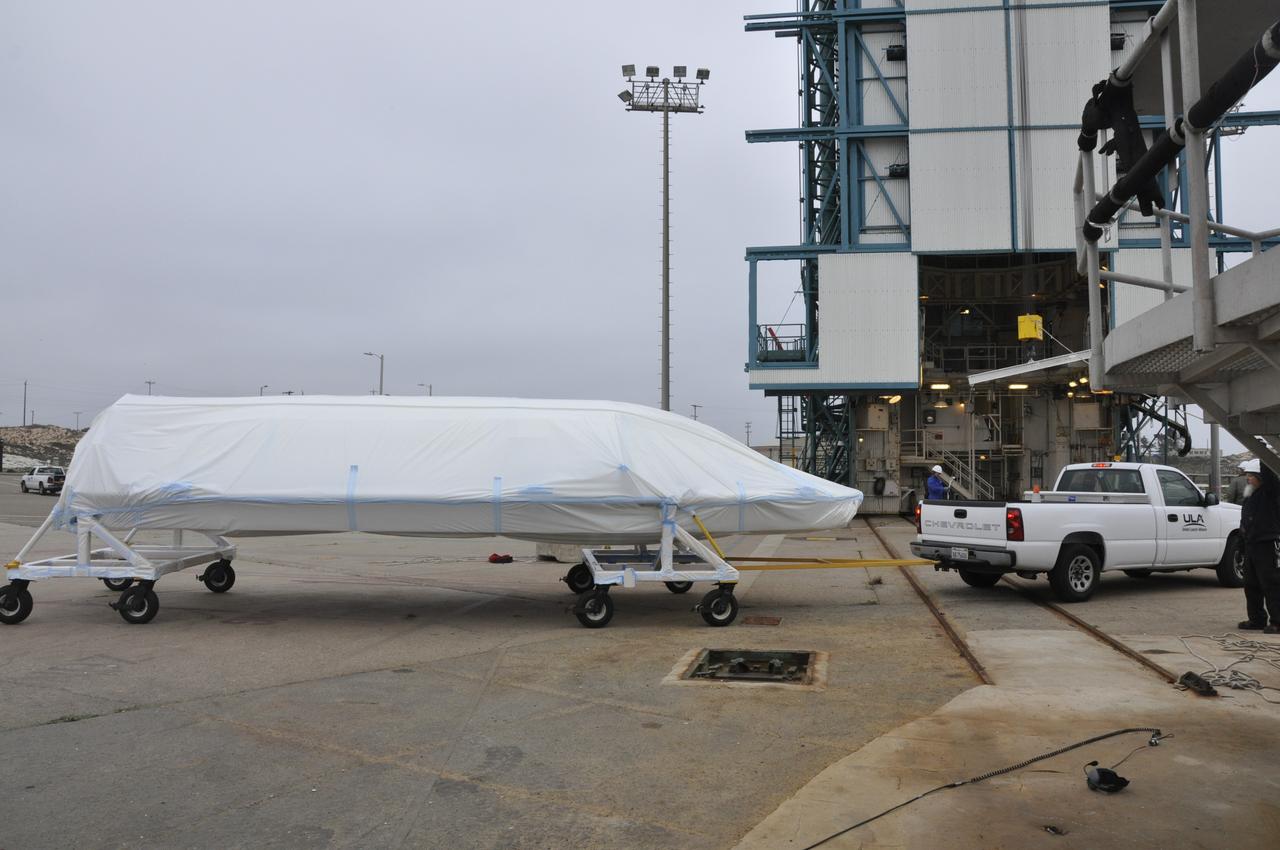 VANDENBERG AIR FORCE BASE, Calif. – The second half of the fairing for NASA's Orbiting Carbon Observatory-2 mission, or OCO-2, arrives at Space Launch Complex 2 on Vandenberg Air Force Base in California. Operations are underway to hoist this section of the fairing into the Delta II launcher's environmental enclosure, or clean room, at the top of the tower where the other half already is in position. The fairing will protect OCO-2 during launch aboard a United Launch Alliance Delta II rocket from Space Launch Complex 2 in July. The observatory will collect precise global measurements of carbon dioxide in the Earth's atmosphere and provide scientists with a better idea of the chemical compound's impacts on climate change. Scientists will analyze this data to improve our understanding of the natural processes and human activities that regulate the abundance and distribution of this important atmospheric gas. To learn more about OCO-2, visit http://oco.jpl.nasa.gov. Photo credit: NASA/Randy Beaudoin
