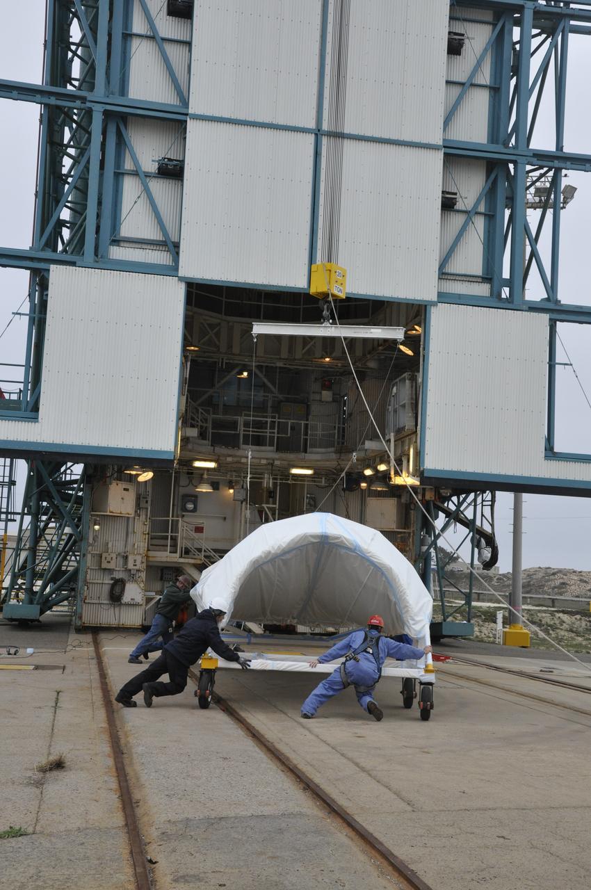VANDENBERG AIR FORCE BASE, Calif. – Workers maneuver half of the fairing for NASA's Orbiting Carbon Observatory-2 mission, or OCO-2, newly arrived at Space Launch Complex 2 on Vandenberg Air Force Base in California, into position underneath the crane. Operations are underway to hoist this section of the fairing into the Delta II launcher's environmental enclosure, or clean room, at the top of the tower where the other half already is in position. The fairing will protect OCO-2 during launch aboard a United Launch Alliance Delta II rocket from Space Launch Complex 2 in July. The observatory will collect precise global measurements of carbon dioxide in the Earth's atmosphere and provide scientists with a better idea of the chemical compound's impacts on climate change. Scientists will analyze this data to improve our understanding of the natural processes and human activities that regulate the abundance and distribution of this important atmospheric gas. To learn more about OCO-2, visit http://oco.jpl.nasa.gov. Photo credit: NASA/Randy Beaudoin