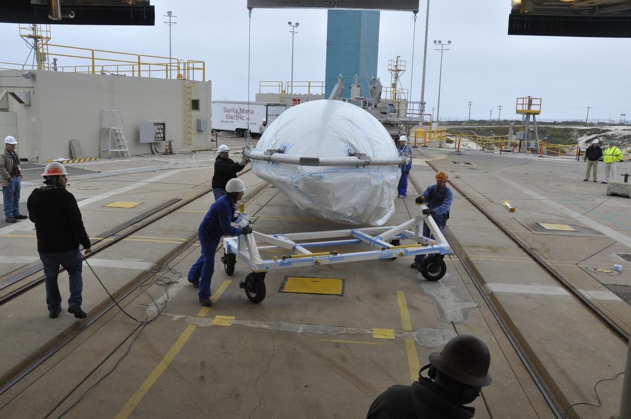 VANDENBERG AIR FORCE BASE, Calif. – Workers maneuver half of the fairing for NASA's Orbiting Carbon Observatory-2 mission, or OCO-2, newly arrived at Space Launch Complex 2 on Vandenberg Air Force Base in California, into position underneath the crane. Operations are underway to hoist this section of the fairing into the Delta II launcher's environmental enclosure, or clean room, at the top of the tower where the other half already is in position. The fairing will protect OCO-2 during launch aboard a United Launch Alliance Delta II rocket from Space Launch Complex 2 in July. The observatory will collect precise global measurements of carbon dioxide in the Earth's atmosphere and provide scientists with a better idea of the chemical compound's impacts on climate change. Scientists will analyze this data to improve our understanding of the natural processes and human activities that regulate the abundance and distribution of this important atmospheric gas. To learn more about OCO-2, visit http://oco.jpl.nasa.gov. Photo credit: NASA/Randy Beaudoin