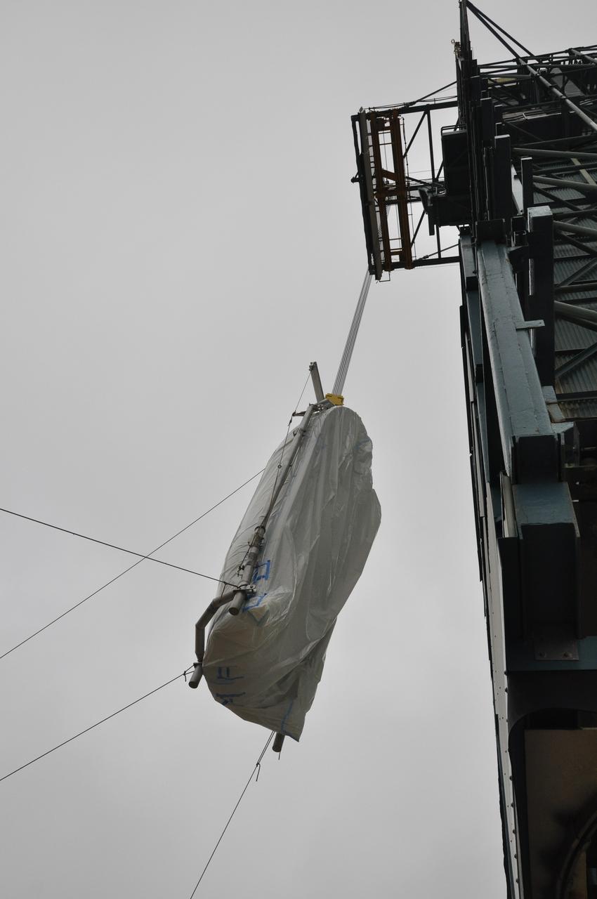VANDENBERG AIR FORCE BASE, Calif. – A crane lifts half of the fairing for NASA's Orbiting Carbon Observatory-2 mission, or OCO-2, up the side of the mobile service tower at Space Launch Complex 2 on Vandenberg Air Force Base in California. Operations are underway to hoist this section of the fairing into the Delta II launcher's environmental enclosure, or clean room, at the top of the tower where the other half is already in position. The fairing will protect OCO-2 during launch aboard a United Launch Alliance Delta II rocket from Space Launch Complex 2 in July. The observatory will collect precise global measurements of carbon dioxide in the Earth's atmosphere and provide scientists with a better idea of the chemical compound's impacts on climate change. Scientists will analyze this data to improve our understanding of the natural processes and human activities that regulate the abundance and distribution of this important atmospheric gas. To learn more about OCO-2, visit http://oco.jpl.nasa.gov. Photo credit: NASA/Randy Beaudoin