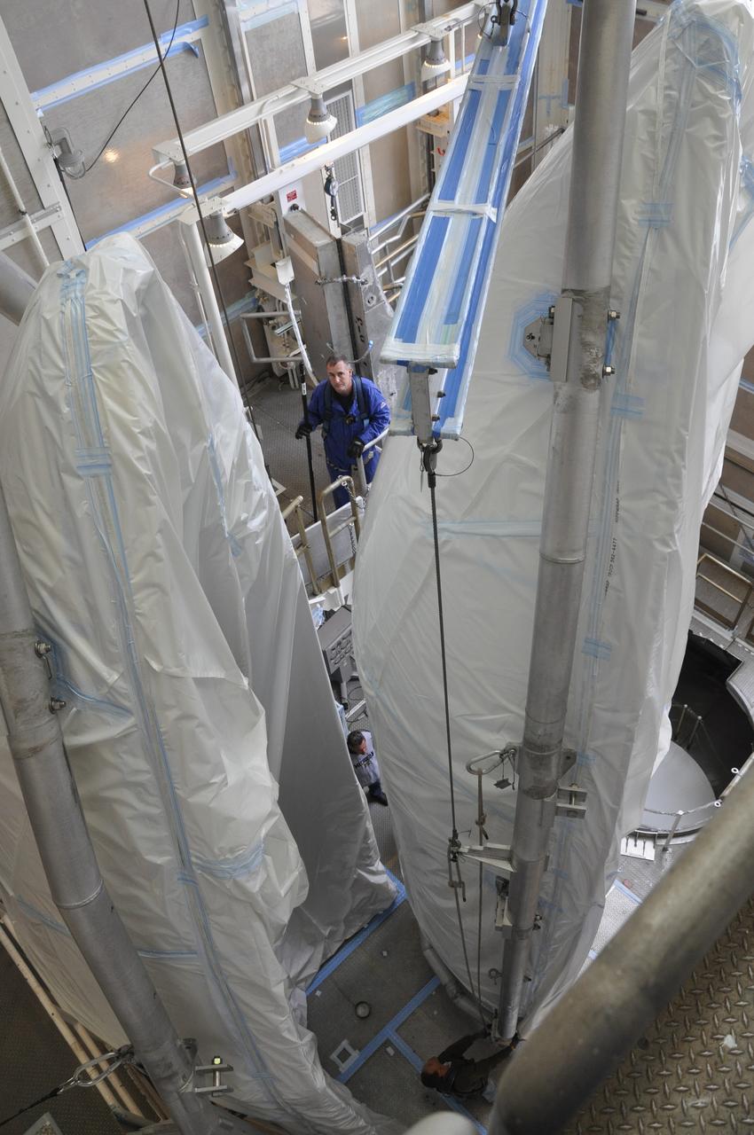 VANDENBERG AIR FORCE BASE, Calif. – Both halves of the fairing for NASA's Orbiting Carbon Observatory-2 mission, or OCO-2, are moved into position in the environmental enclosure, or clean room, at the top of the Delta II launcher at Space Launch Complex 2 on Vandenberg Air Force Base in California. The fairing will protect OCO-2 during launch aboard a United Launch Alliance Delta II rocket from Space Launch Complex 2 in July. The observatory will collect precise global measurements of carbon dioxide in the Earth's atmosphere and provide scientists with a better idea of the chemical compound's impacts on climate change. Scientists will analyze this data to improve our understanding of the natural processes and human activities that regulate the abundance and distribution of this important atmospheric gas. To learn more about OCO-2, visit http://oco.jpl.nasa.gov. Photo credit: NASA/Randy Beaudoin