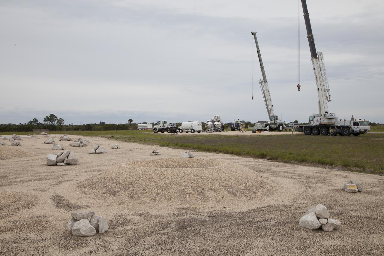 CAPE CANAVERAL, Fla. – NASA's Project Morpheus prototype lander is positioned near a new launch site at the north end of the Shuttle Landing Facility at NASA’s Kennedy Space Center in Florida for a tether test. The launch pad was moved to a different location at the landing facility to support the next phase of flight testing. Project Morpheus tests NASA’s automated landing and hazard avoidance technology, or ALHAT, and an engine that runs on liquid oxygen and methane, or green propellants, into a fully-operational lander that could deliver cargo to other planetary surfaces. In the foreground of the photo is the ALHAT field. The landing facility provides the lander with the kind of field necessary for realistic testing, complete with rocks, craters and hazards to avoid. Morpheus’ ALHAT payload allows it to navigate to clear landing sites amidst rocks, craters and other hazards during its descent. Project Morpheus is being managed under the Advanced Exploration Systems, or AES, Division in NASA’s Human Exploration and Operations Mission Directorate. The efforts in AES pioneer new approaches for rapidly developing prototype systems, demonstrating key capabilities and validating operational concepts for future human missions beyond Earth orbit. For more information on Project Morpheus, visit http://morpheuslander.jsc.nasa.gov/. Photo credit: NASA/Ben Smegelsky