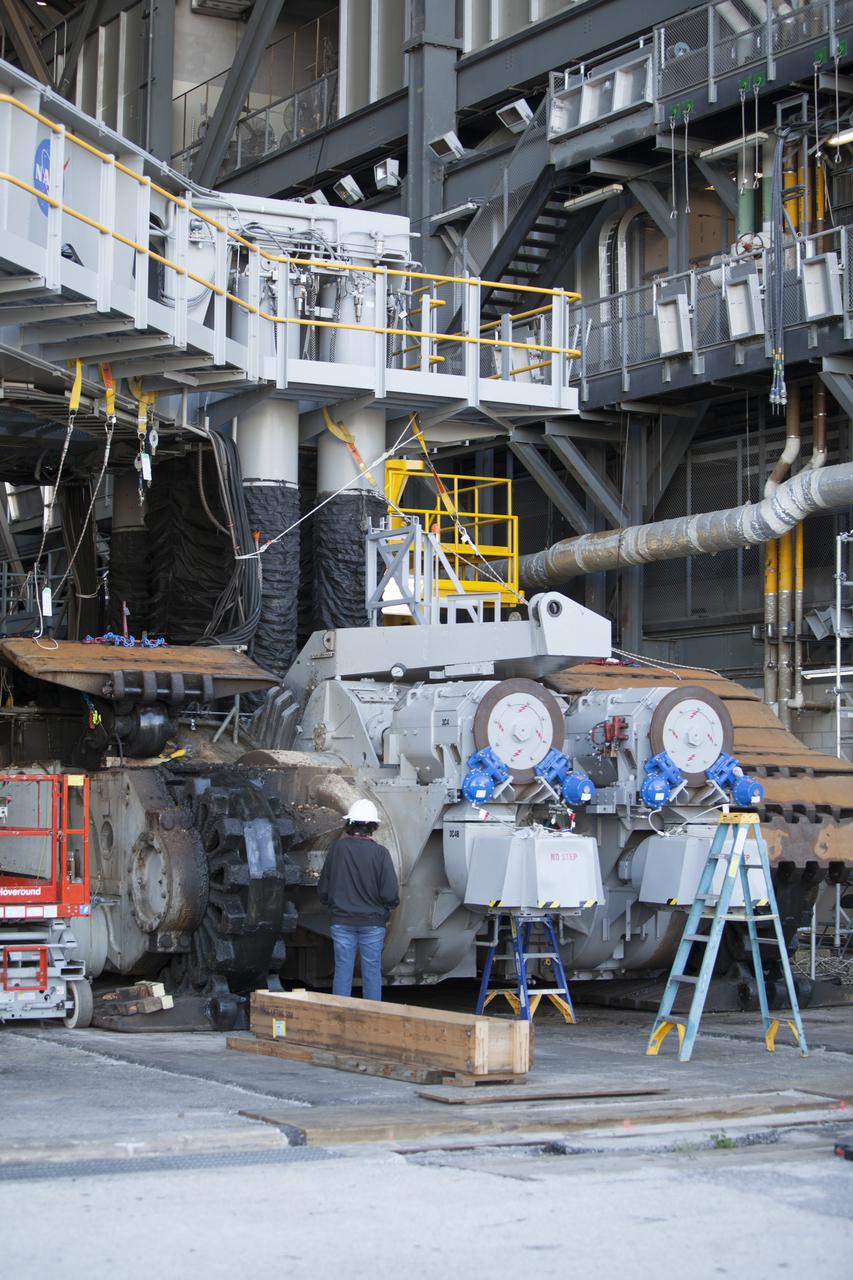 CAPE CANAVERAL, Fla. – Inside the Vehicle Assembly Building at NASA’s Kennedy Space Center in Florida, a portion of the treads on the C truck of crawler-transporter 2, or CT-2, have been removed from the vehicle. The treads are being removed in order to gain access to remove the gear boxes. Work continues in high bay 2 to upgrade CT-2. The modifications are designed to ensure CT-2’s ability to transport launch vehicles currently in development, such as the agency’s Space Launch System, to the launch pad. The Ground Systems Development and Operations Program office at Kennedy is overseeing the upgrades. For more than 45 years the crawler-transporters were used to transport the mobile launcher platform and the Apollo-Saturn V rockets and, later, space shuttles to Launch Pads 39A and B. For more information, visit: http://www.nasa.gov/exploration/systems/ground/crawler-transporter. Photo credit: NASA/Dimitri Gerondidakis
