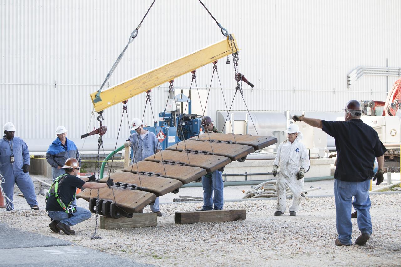 CAPE CANAVERAL, Fla. – A section of the treads on the C truck of crawler-transporter 2, or CT-2, have been removed and are being stored near the Vehicle Assembly Building at NASA’s Kennedy Space Center in Florida. The treads are being removed from the crawler in order to gain access to remove the gear boxes. Work continues in high bay 2 to upgrade CT-2. The modifications are designed to ensure CT-2’s ability to transport launch vehicles currently in development, such as the agency’s Space Launch System, to the launch pad. The Ground Systems Development and Operations Program office at Kennedy is overseeing the upgrades. For more than 45 years the crawler-transporters were used to transport the mobile launcher platform and the Apollo-Saturn V rockets and, later, space shuttles to Launch Pads 39A and B. For more information, visit: http://www.nasa.gov/exploration/systems/ground/crawler-transporter. Photo credit: NASA/Dimitri Gerondidakis