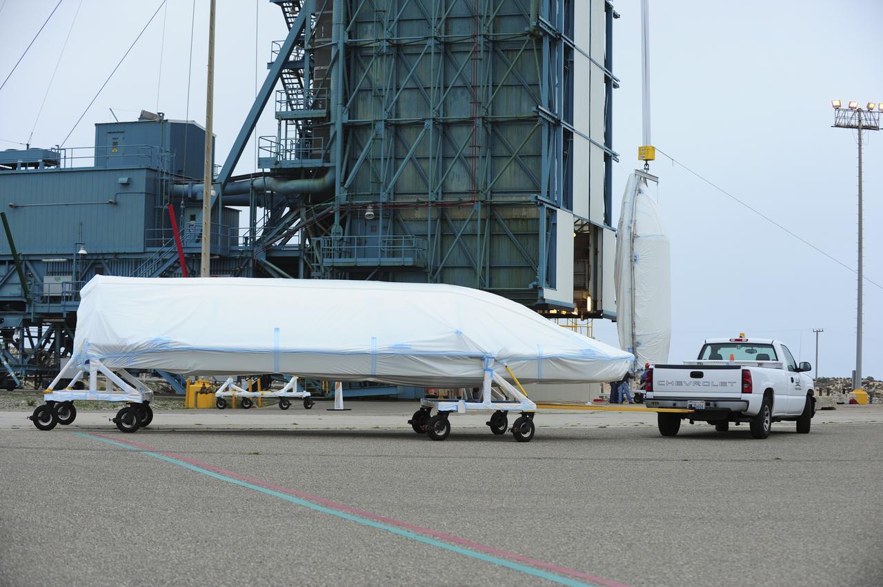 VANDENBERG AIR FORCE BASE, Calif. – Half of the fairing for NASA's Orbiting Carbon Observatory-2 mission, or OCO-2, is towed from the Building 836 hangar to Space Launch Complex 2 on Vandenberg Air Force Base in California. Operations have begun to hoist the sections of the fairing into the Delta II launcher's environmental enclosure, or clean room, at the top of the pad's mobile service tower. The fairing will protect OCO-2 during launch aboard a United Launch Alliance Delta II rocket from Space Launch Complex 2 in July. The observatory will collect precise global measurements of carbon dioxide in the Earth's atmosphere and provide scientists with a better idea of the chemical compound's impacts on climate change. Scientists will analyze this data to improve our understanding of the natural processes and human activities that regulate the abundance and distribution of this important atmospheric gas. To learn more about OCO-2, visit http://oco.jpl.nasa.gov. Photo credit: NASA/30th Space Wing, VAFB