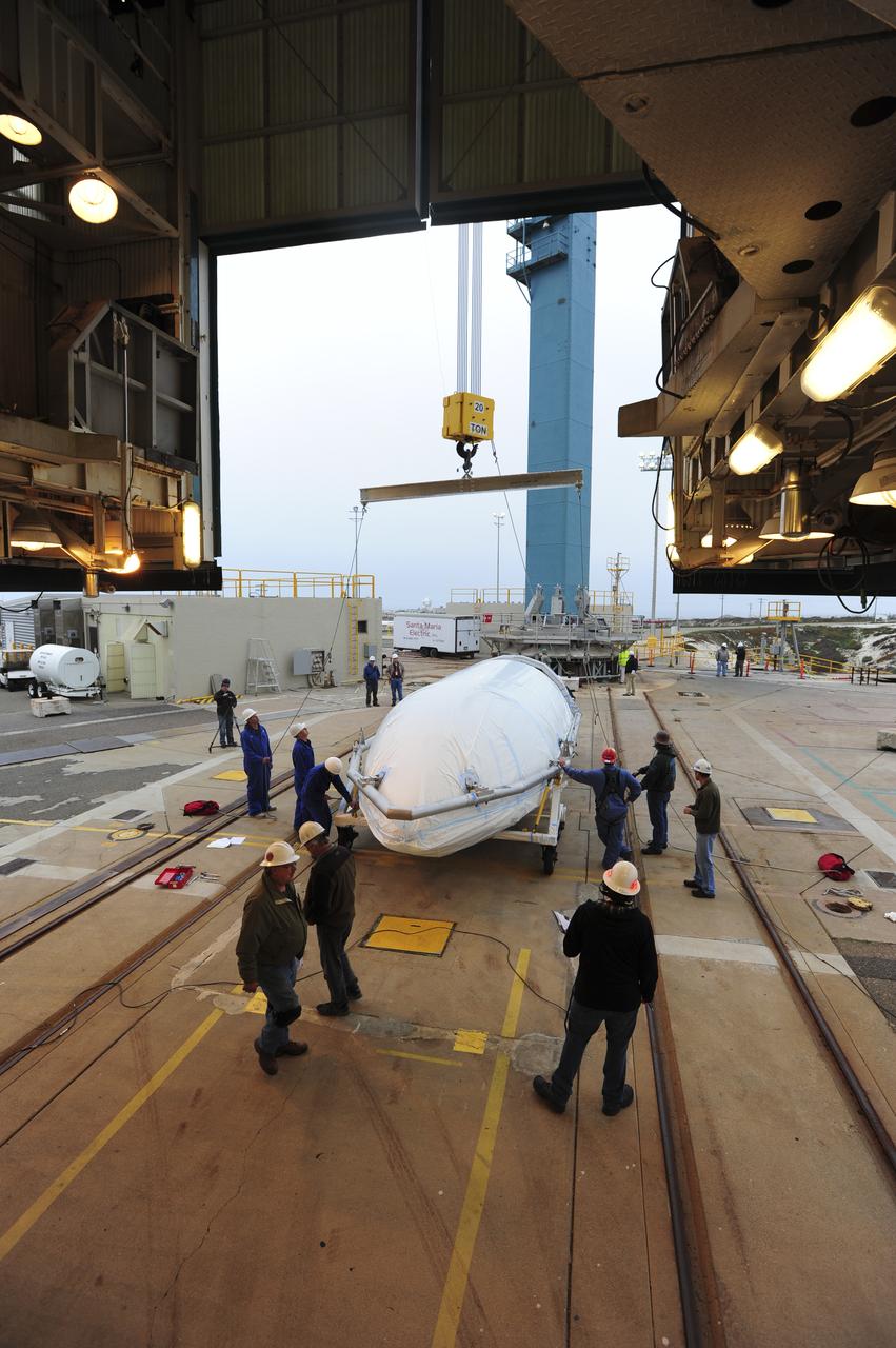 VANDENBERG AIR FORCE BASE, Calif. – Workers attach half of the fairing for NASA's Orbiting Carbon Observatory-2 mission, or OCO-2, to a crane at Space Launch Complex 2 on Vandenberg Air Force Base in California. Operations have begun to hoist the sections of the fairing into the Delta II launcher's environmental enclosure, or clean room, at the top of the pad's mobile service tower. The fairing will protect OCO-2 during launch aboard a United Launch Alliance Delta II rocket from Space Launch Complex 2 in July. The observatory will collect precise global measurements of carbon dioxide in the Earth's atmosphere and provide scientists with a better idea of the chemical compound's impacts on climate change. Scientists will analyze this data to improve our understanding of the natural processes and human activities that regulate the abundance and distribution of this important atmospheric gas. To learn more about OCO-2, visit http://oco.jpl.nasa.gov. Photo credit: NASA/30th Space Wing, VAFB