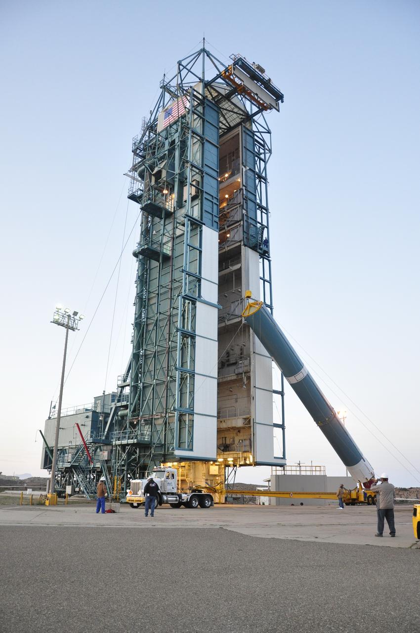 VANDENBERG AIR FORCE BASE, Calif. – The United Launch Alliance Delta II rocket for NASA's Orbiting Carbon Observatory-2 mission, or OCO-2, is lifted into a vertical position beside the mobile service tower at Space Launch Complex 2 on Vandenberg Air Force Base in California. Launch is scheduled for July 2014. The observatory will collect precise global measurements of carbon dioxide in the Earth's atmosphere and provide scientists with a better idea of the chemical compound's impacts on climate change. Scientists will analyze this data to improve our understanding of the natural processes and human activities that regulate the abundance and distribution of this important atmospheric gas. To learn more about OCO-2, visit http://oco.jpl.nasa.gov. Photo credit: NASA/Randy Beaudoin