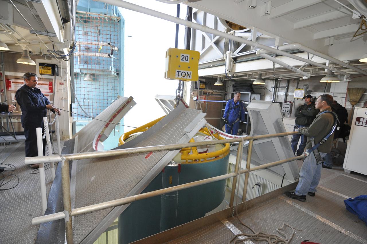 VANDENBERG AIR FORCE BASE, Calif. – Workers in the environmental enclosure, or clean room, at the top of the mobile service tower at Space Launch Complex 2 on Vandenberg Air Force Base in California steady the upper end of the United Launch Alliance Delta II rocket for NASA's Orbiting Carbon Observatory-2 mission, or OCO-2, as work platforms move into position around it. Launch is scheduled for July 2014. The observatory will collect precise global measurements of carbon dioxide in the Earth's atmosphere and provide scientists with a better idea of the chemical compound's impacts on climate change. Scientists will analyze this data to improve our understanding of the natural processes and human activities that regulate the abundance and distribution of this important atmospheric gas. To learn more about OCO-2, visit http://oco.jpl.nasa.gov. Photo credit: NASA/Randy Beaudoin
