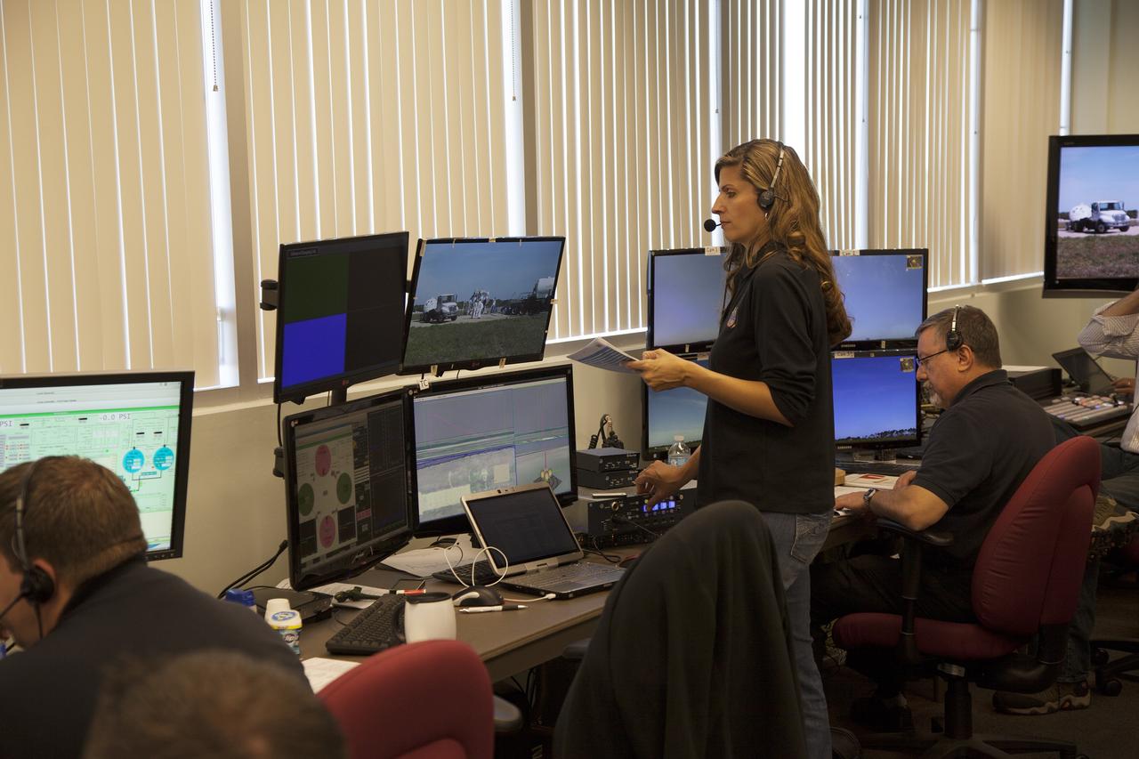 CAPE CANAVERAL, Fla. – Engineers monitor preparations inside a control room for the free flight test of NASA's Project Morpheus prototype lander at a new launch site at the north end of the Shuttle Landing Facility at NASA's Kennedy Space Center in Florida. The 96-second test began at 4:21 p.m. EDT with the Morpheus lander launching from the ground over the flame trench and ascending more than 800 feet at a peak speed of 36 mph. The vehicle with its recently installed autonomous landing and hazard avoidance technology, or ALHAT, sensors surveyed the hazard field to determine safe landing sites. Morpheus then flew forward and downward covering 1,300 feet while performing a 78-foot divert to simulate a hazard avoidance maneuver. The lander descended and landed on a dedicated pad inside the ALHAT field. Project Morpheus tests NASA’s ALHAT, and an engine that runs on liquid oxygen and methane, or green propellants, into a fully-operational lander that could deliver cargo to other planetary surfaces. The landing facility provides the lander with the kind of field necessary for realistic testing, complete with rocks, craters and hazards to avoid. Morpheus’ ALHAT payload allows it to navigate to clear landing sites amidst rocks, craters and other hazards during its descent. Project Morpheus is being managed under the Advanced Exploration Systems, or AES, Division in NASA’s Human Exploration and Operations Mission Directorate. The efforts in AES pioneer new approaches for rapidly developing prototype systems, demonstrating key capabilities and validating operational concepts for future human missions beyond Earth orbit. For more information on Project Morpheus, visit http://morpheuslander.jsc.nasa.gov/. Photo credit: NASA/Frankie Martin