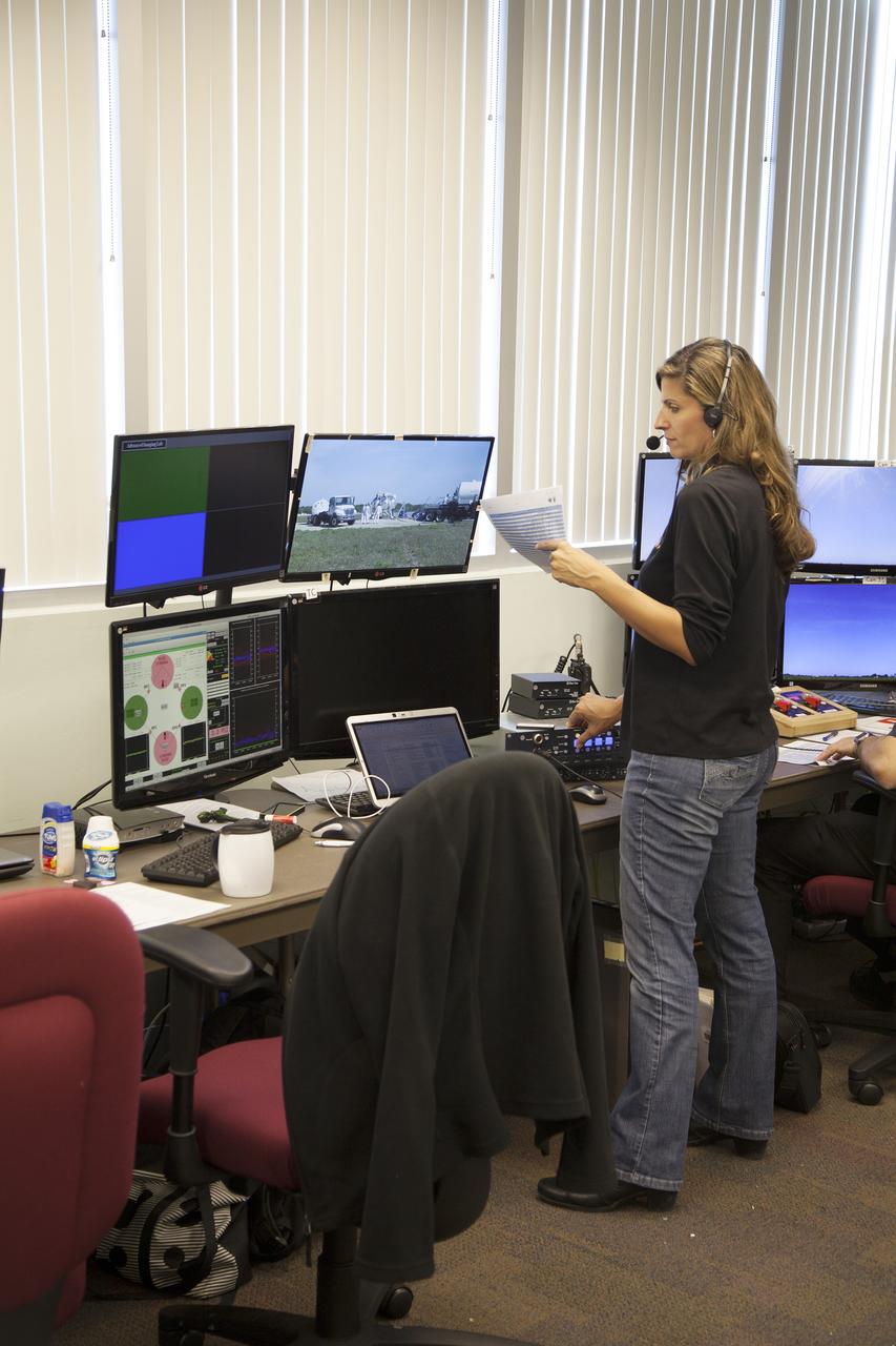 CAPE CANAVERAL, Fla. – Engineers monitor preparations inside a control room for the free flight test of NASA's Project Morpheus prototype lander at a new launch site at the north end of the Shuttle Landing Facility at NASA's Kennedy Space Center in Florida. The 96-second test began at 4:21 p.m. EDT with the Morpheus lander launching from the ground over the flame trench and ascending more than 800 feet at a peak speed of 36 mph. The vehicle with its recently installed autonomous landing and hazard avoidance technology, or ALHAT, sensors surveyed the hazard field to determine safe landing sites. Morpheus then flew forward and downward covering 1,300 feet while performing a 78-foot divert to simulate a hazard avoidance maneuver. The lander descended and landed on a dedicated pad inside the ALHAT field. Project Morpheus tests NASA’s ALHAT, and an engine that runs on liquid oxygen and methane, or green propellants, into a fully-operational lander that could deliver cargo to other planetary surfaces.    The landing facility provides the lander with the kind of field necessary for realistic testing, complete with rocks, craters and hazards to avoid. Morpheus’ ALHAT payload allows it to navigate to clear landing sites amidst rocks, craters and other hazards during its descent. Project Morpheus is being managed under the Advanced Exploration Systems, or AES, Division in NASA’s Human Exploration and Operations Mission Directorate. The efforts in AES pioneer new approaches for rapidly developing prototype systems, demonstrating key capabilities and validating operational concepts for future human missions beyond Earth orbit. For more information on Project Morpheus, visit http://morpheuslander.jsc.nasa.gov/.  Photo credit: NASA/Frankie Martin
