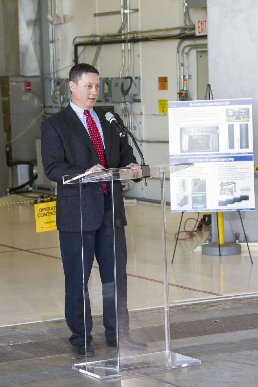 CAPE CANAVERAL, Fla. – Tony Corak, manager of nondestructive testing services for PaR Systems Inc., speaks during an Open House event at Hangar N at Cape Canaveral Air Force Station in Florida, to celebrate the one-year anniversary of a partnership with NASA Kennedy Space Center. Under a 15-year lease agreement, PaR Systems is utilizing Hangar N and its unique nondestructive testing equipment.     The partnership agreement was established by Kennedy's Center Planning and Development Directorate. The agreement is just one example of the types of partnerships that Kennedy is seeking to create a multi-user spaceport.  Photo credit: NASA/Cory Huston