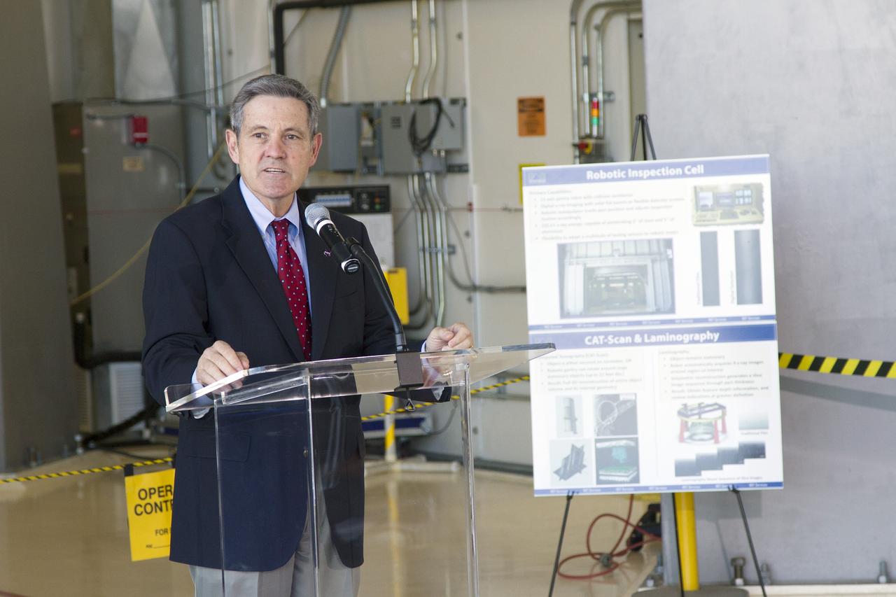 CAPE CANAVERAL, Fla. – Kennedy Space Center Director Bob Cabana speaks during an Open House event at Hangar N at Cape Canaveral Air Force Station in Florida, to celebrate the one-year anniversary of PaR Systems' partnership with Kennedy. Under a 15-year lease agreement, PaR Systems is utilizing Hangar N and its unique nondestructive testing equipment. Behind Cabana is the robotic inspection cell that contains an automated X-ray system once used to scan the aft skirts of the solid rocket boosters for the space shuttle.    The partnership agreement was established by Kennedy's Center Planning and Development Directorate. The agreement is just one example of the types of partnerships that Kennedy is seeking to create a multi-user spaceport.  Photo credit: NASA/Cory Huston
