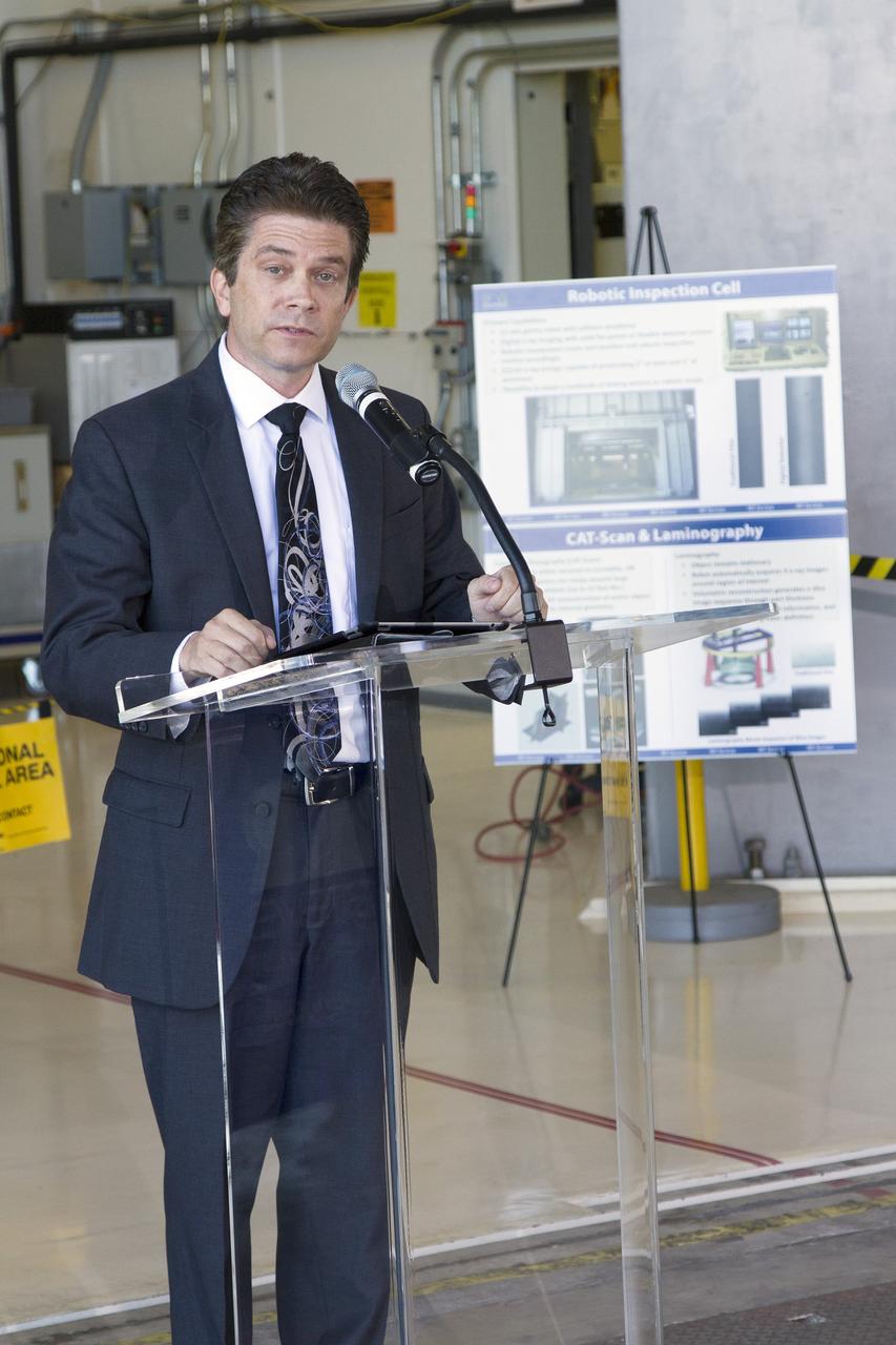CAPE CANAVERAL, Fla. – Robert Salonen, business development director with the Economic Development Commission of Florida's Space Coast, speaks during an Open House event at Hangar N at Cape Canaveral Air Force Station in Florida, to celebrate the one-year anniversary of PaR Systems' partnership with Kennedy Space Center. Under a 15-year lease agreement, PaR Systems is utilizing Hangar N and its unique nondestructive testing equipment.     The partnership agreement was established by Kennedy's Center Planning and Development Directorate. The agreement is just one example of the types of partnerships that Kennedy is seeking to create a multi-user spaceport.  Photo credit: NASA/Cory Huston